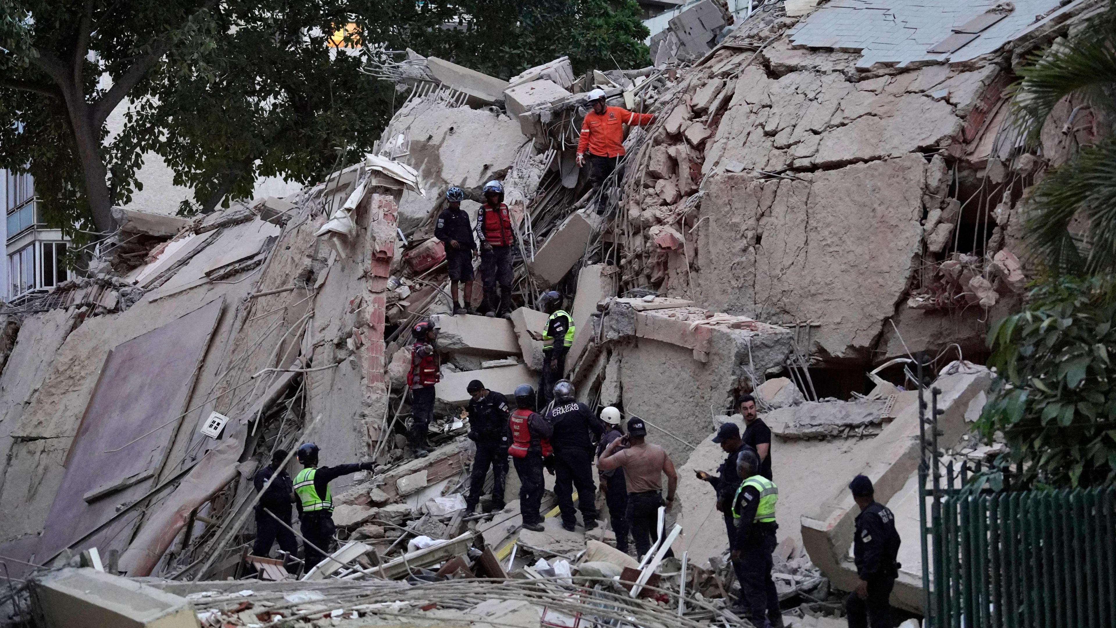 Rescuers search for victims in a collapsed building following an earthquake in Caracas on June 24, 2026.