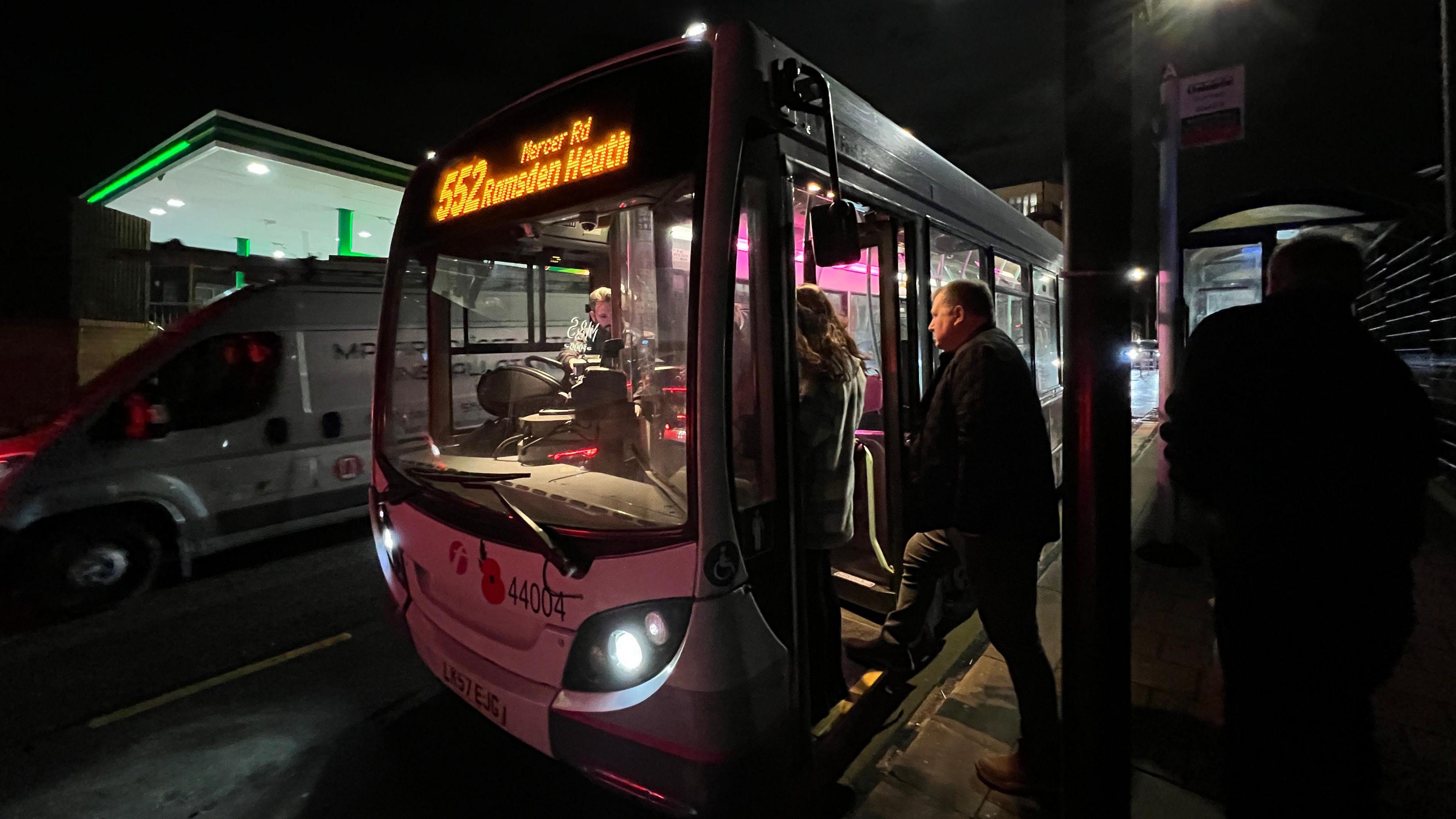 Man getting on 552 bus for Ramsden Heath in dark