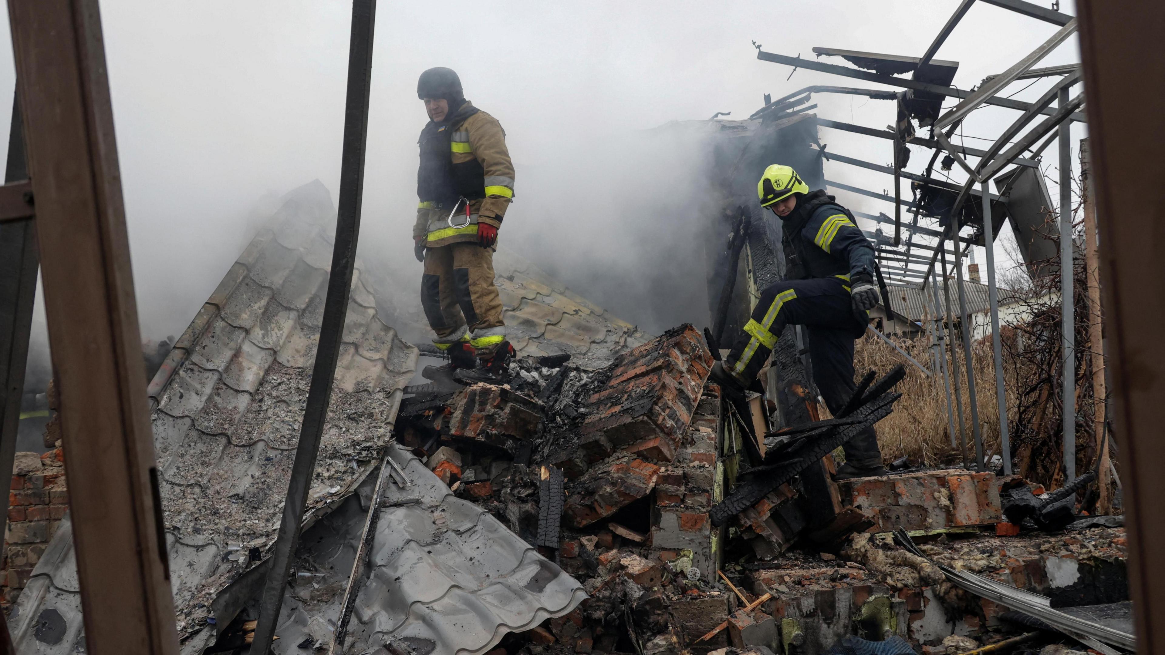 Firefighters work at the site of residential buildings hit by a Russian drone strike