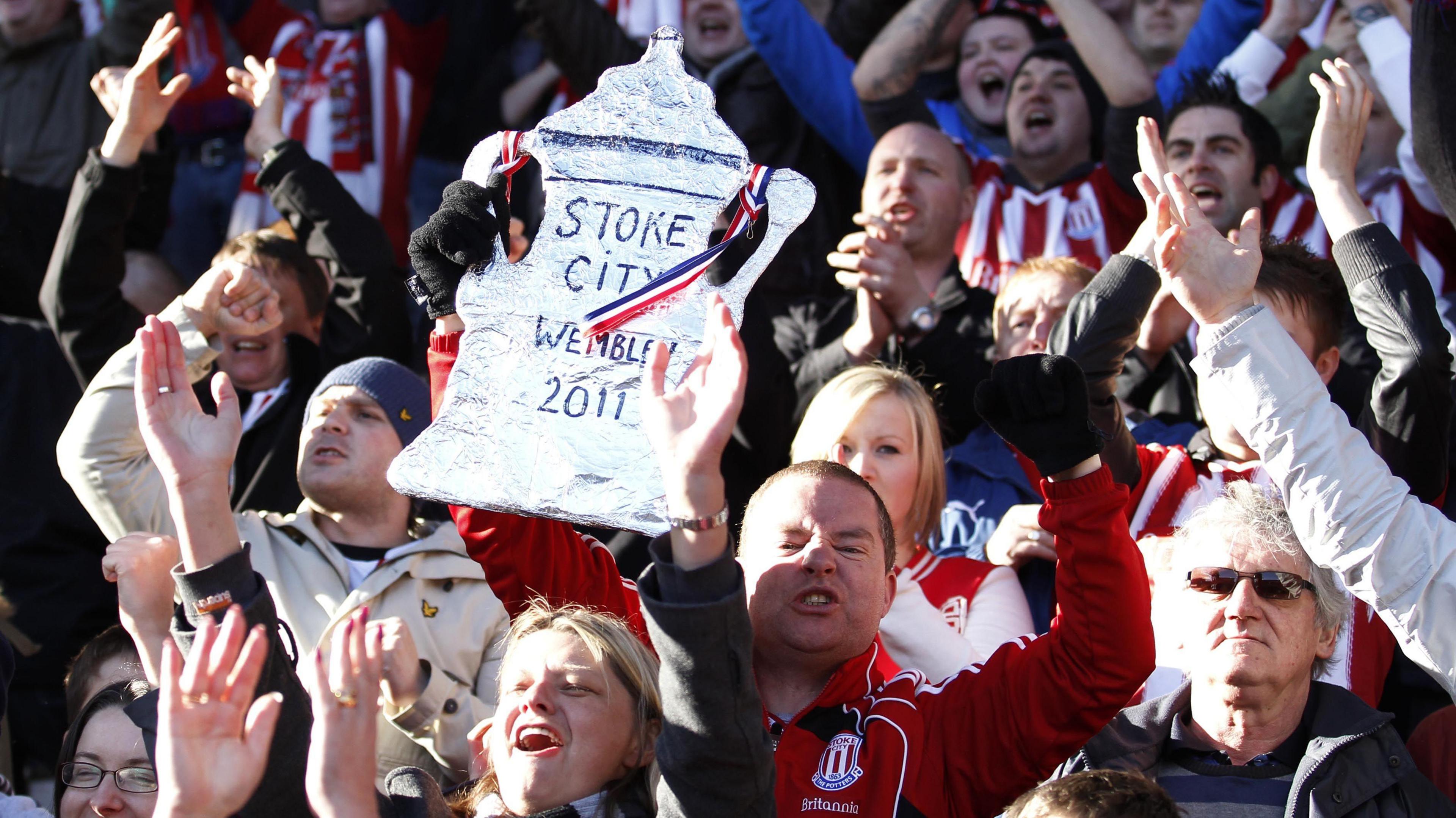 Stoke fans celebrate their FA Cup win over West Ham with a tin-foil FA Cup