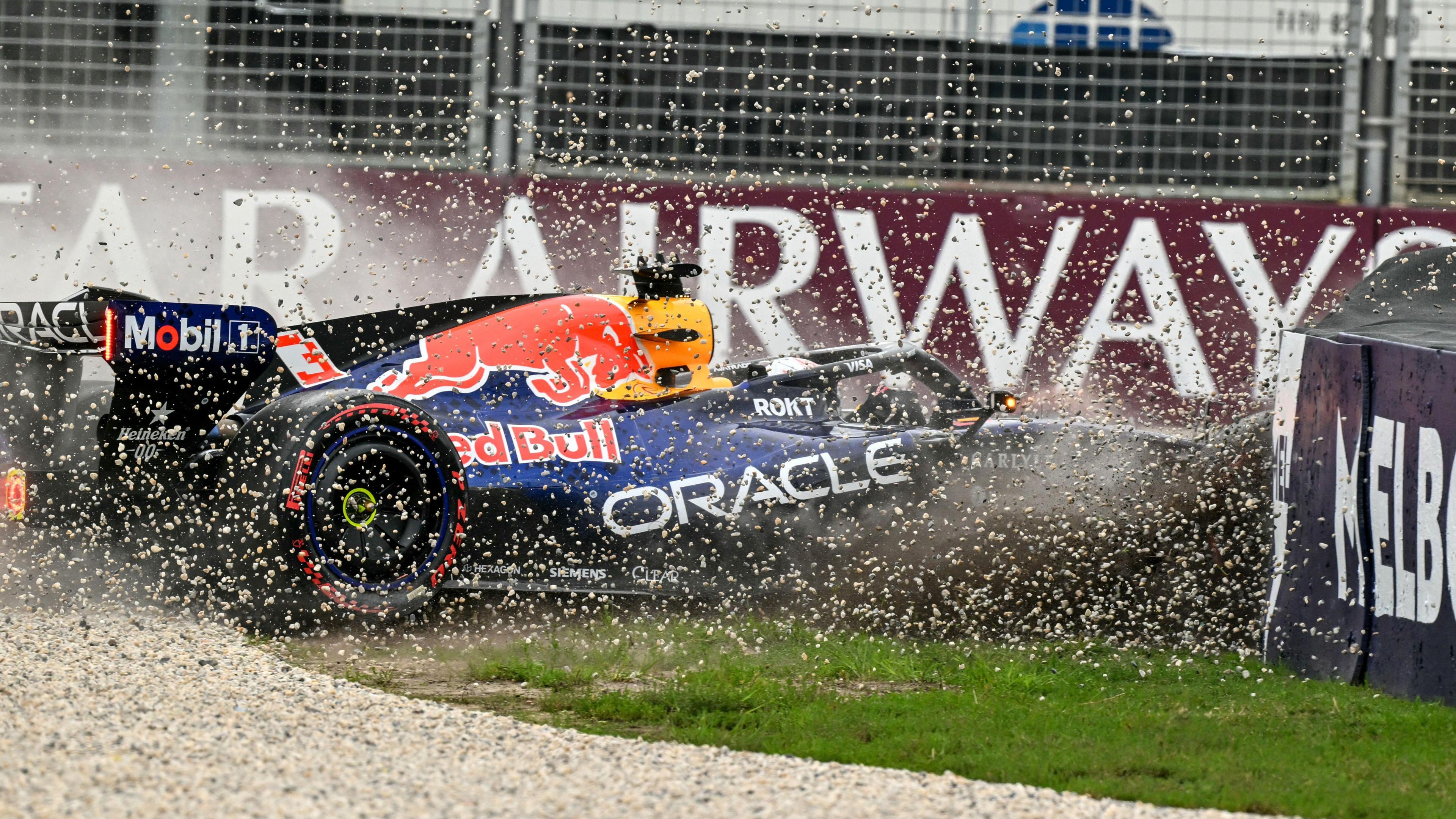 Gravel flies up as Red Bull's Max Verstappen crashes into the barrier during qualifying for the Australian Grand Prix