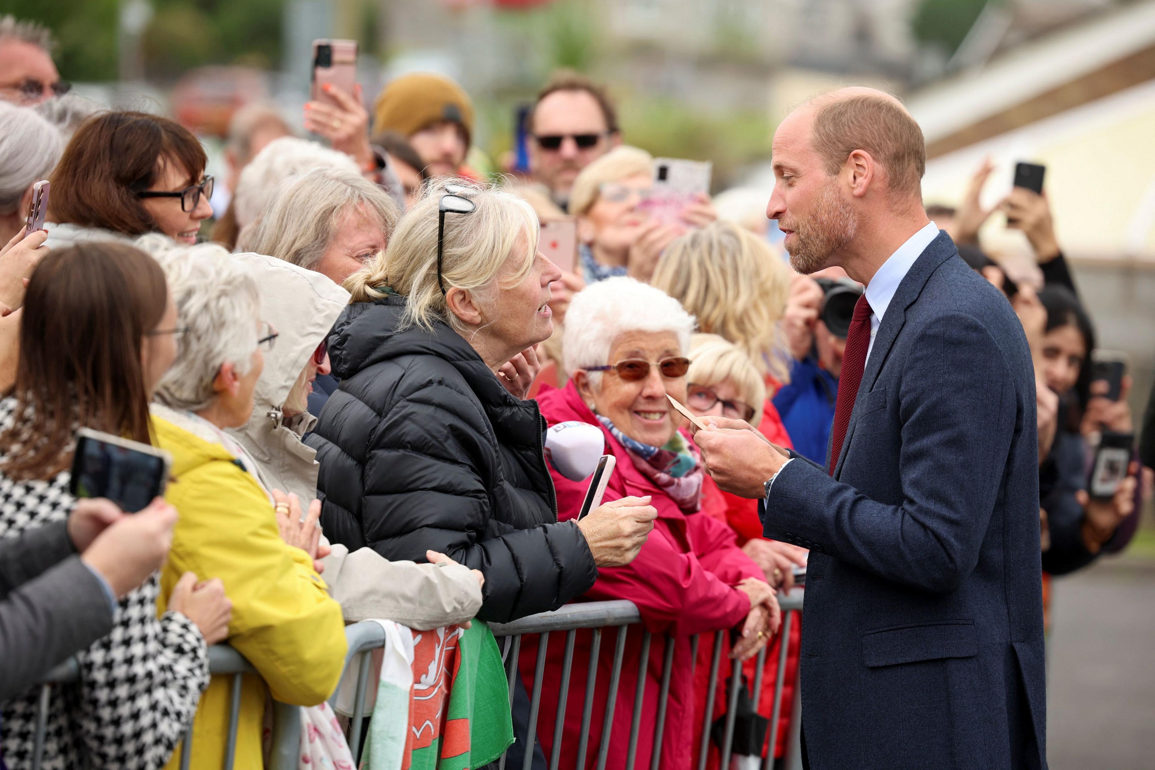 Prince William talking to members of the public on his visit to Wales