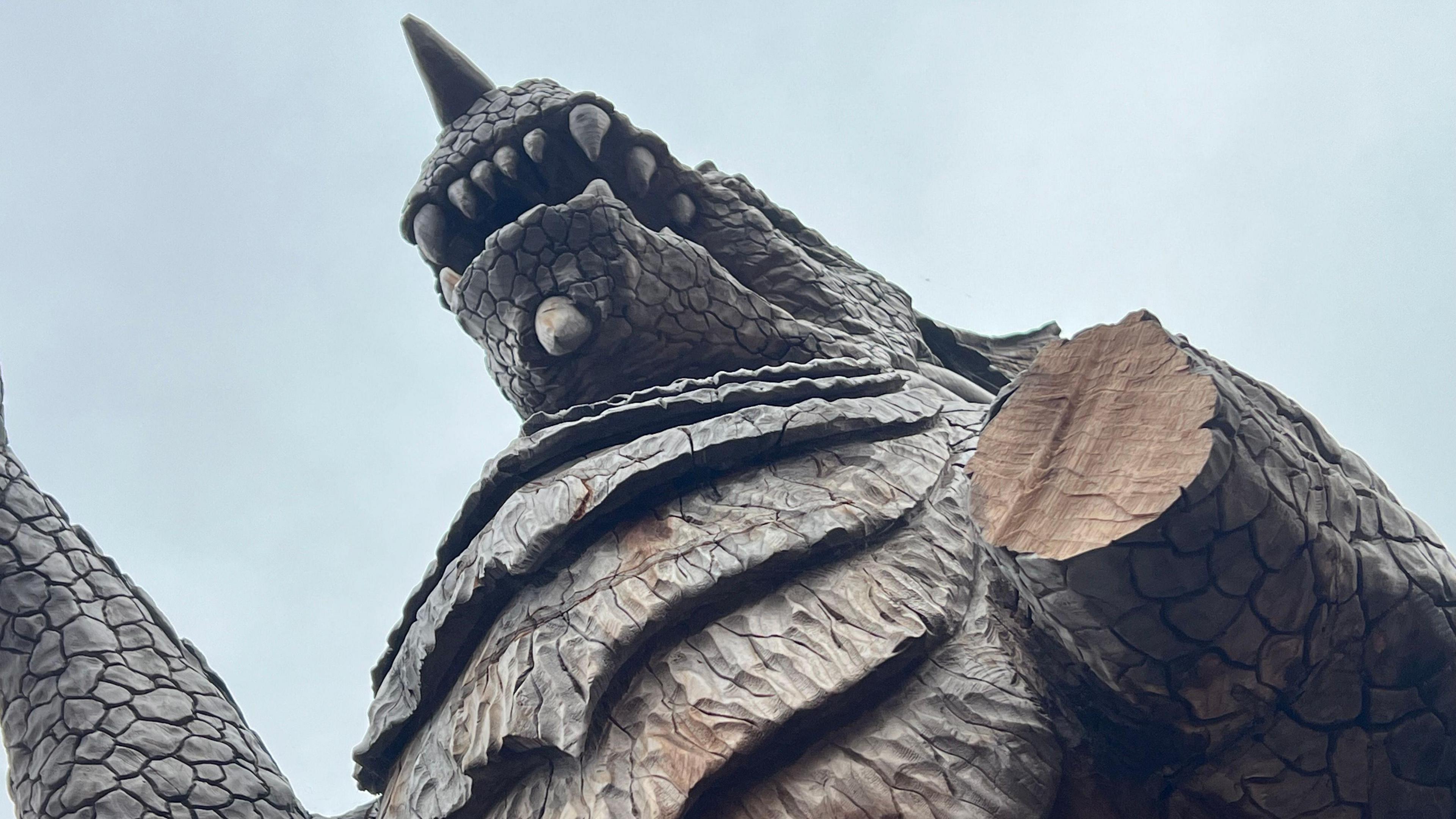 The picture was taken underneath the dragon. The image clearly shows the missing arm. The picture was taken on a cloudy day.