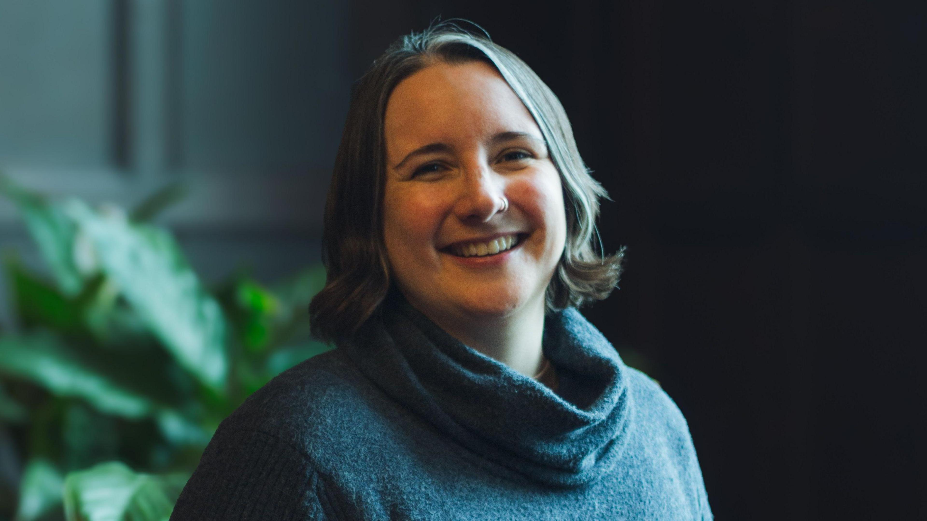 Leila Powell, former astrophysicist, smiling. 