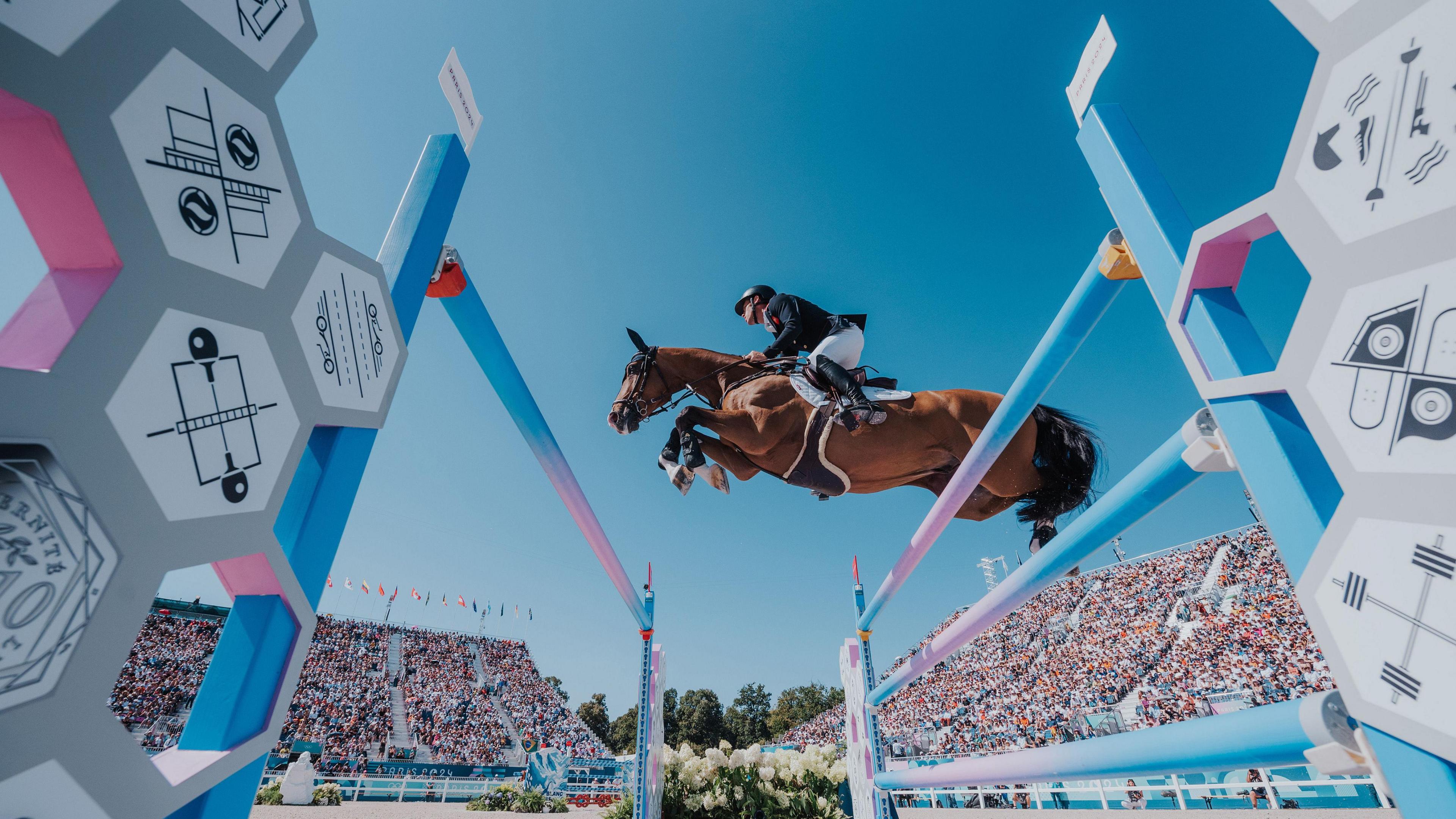 Great Britain's Scott Brash and Hello Jefferson clear a colossal fence in the Individual Jumping Qualifier at the Paris Olympics, hosted at the Chateau de Versailles. They had already helped their team to a gold medal just days prior