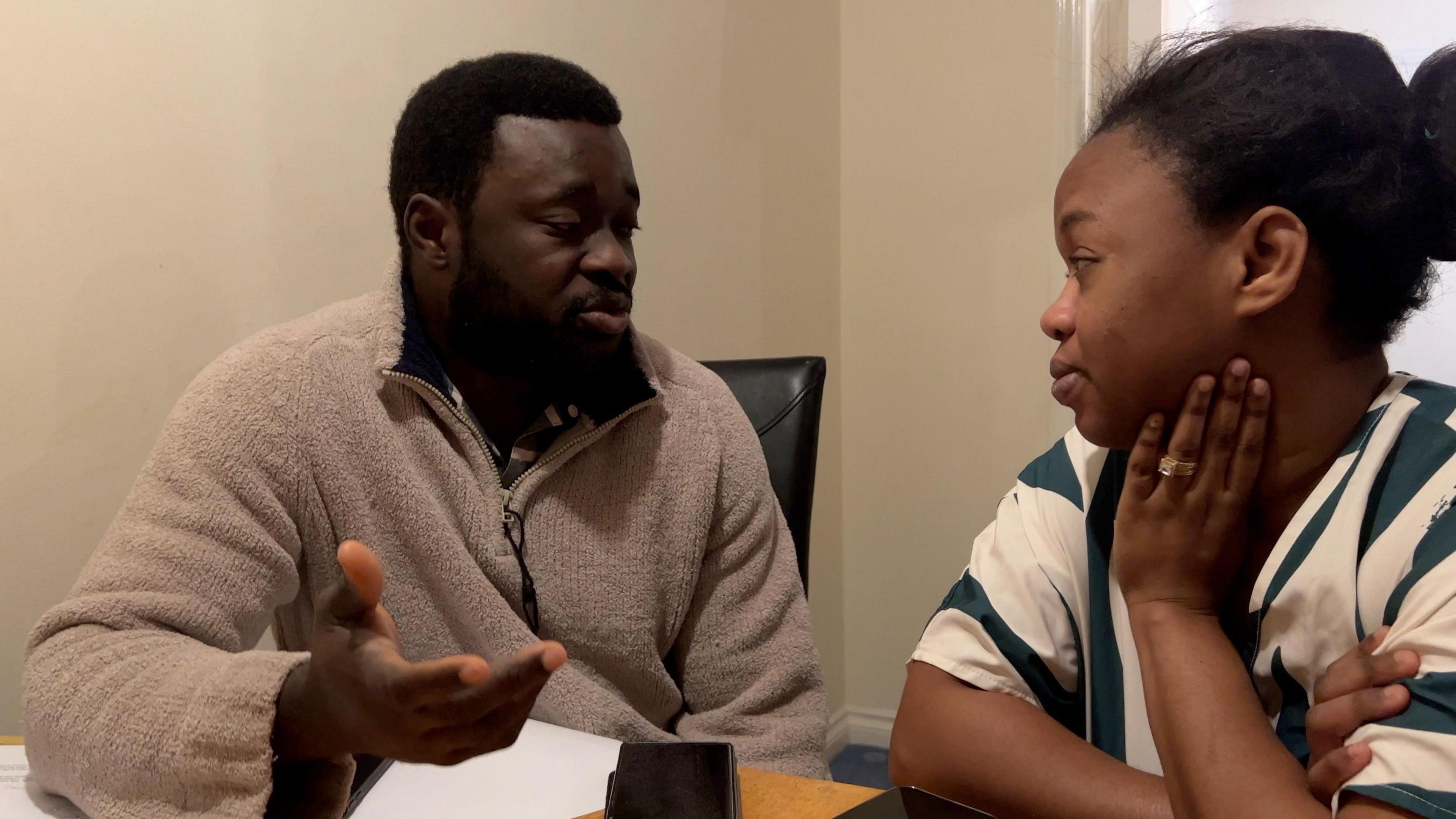 Osei and Esther discuss what happens now as they sit at the dining table