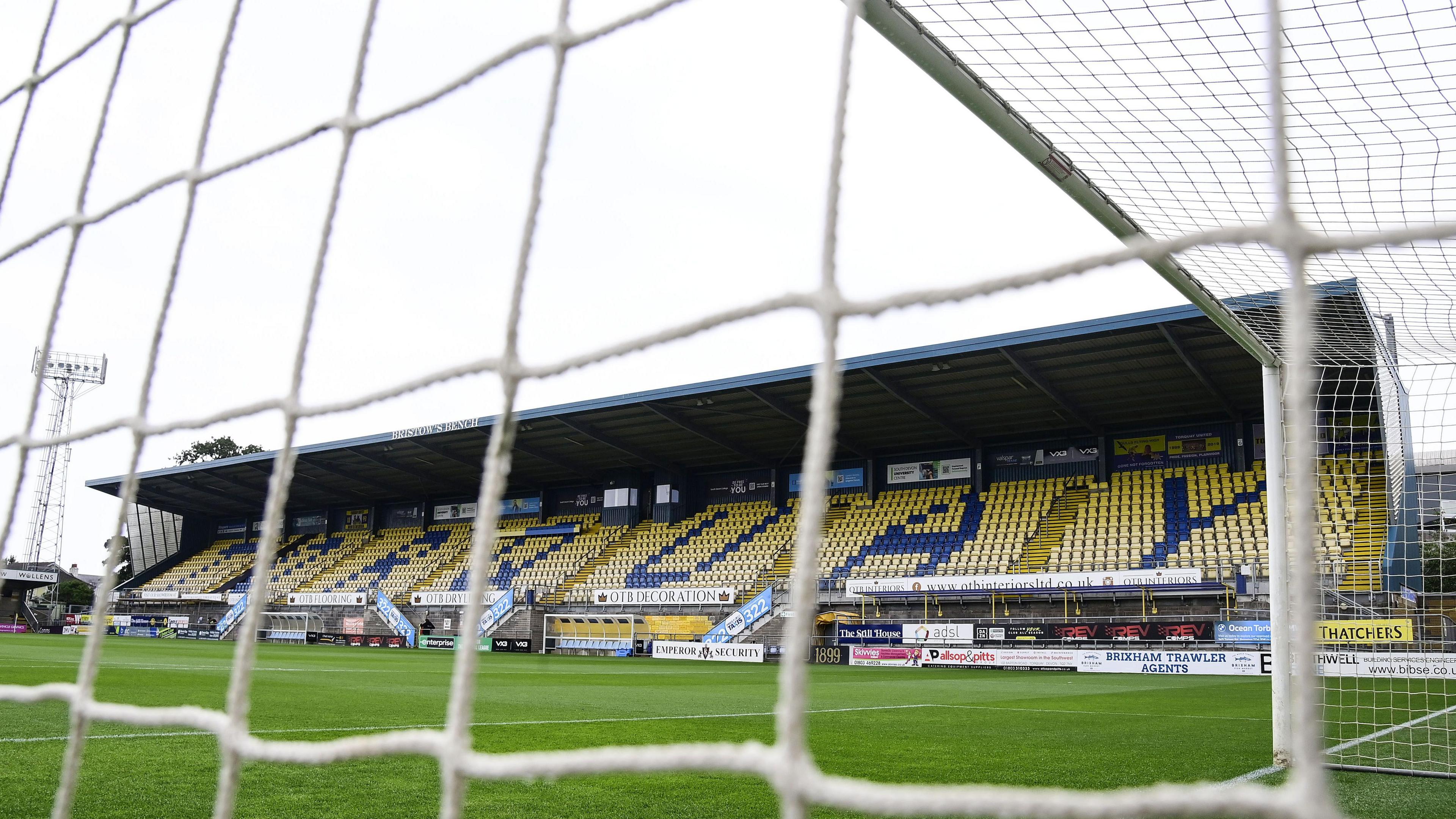 General view of Torquay United's stadium, Plainmoor, from behind a goal net.