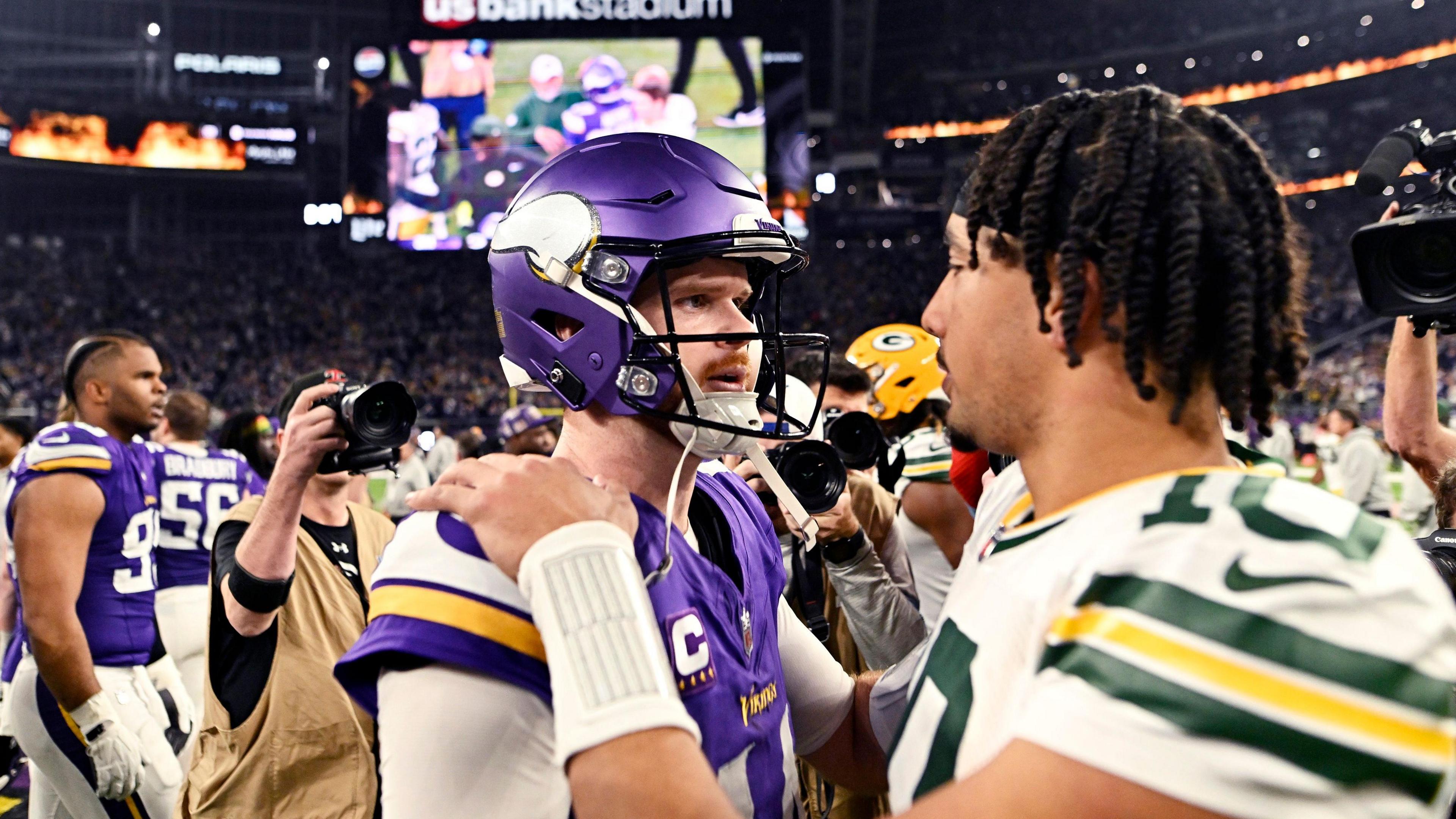 Minnesota Vikings quarterback Sam Darnold and Green Bay Packers quarterback Jordan Love shake hands after playing in the NFL