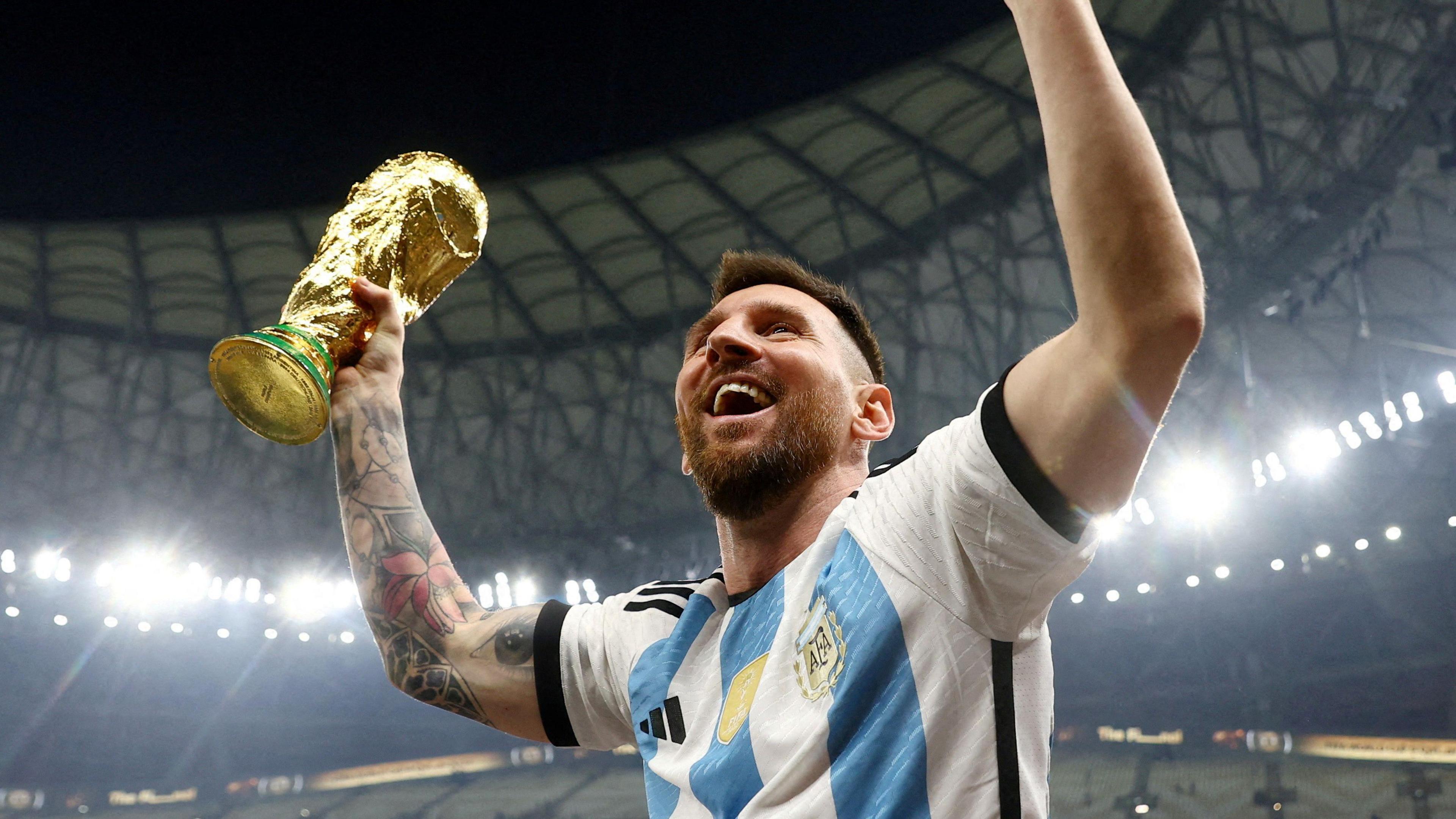 Argentina's Lionel Messi holds the World Cup trophy