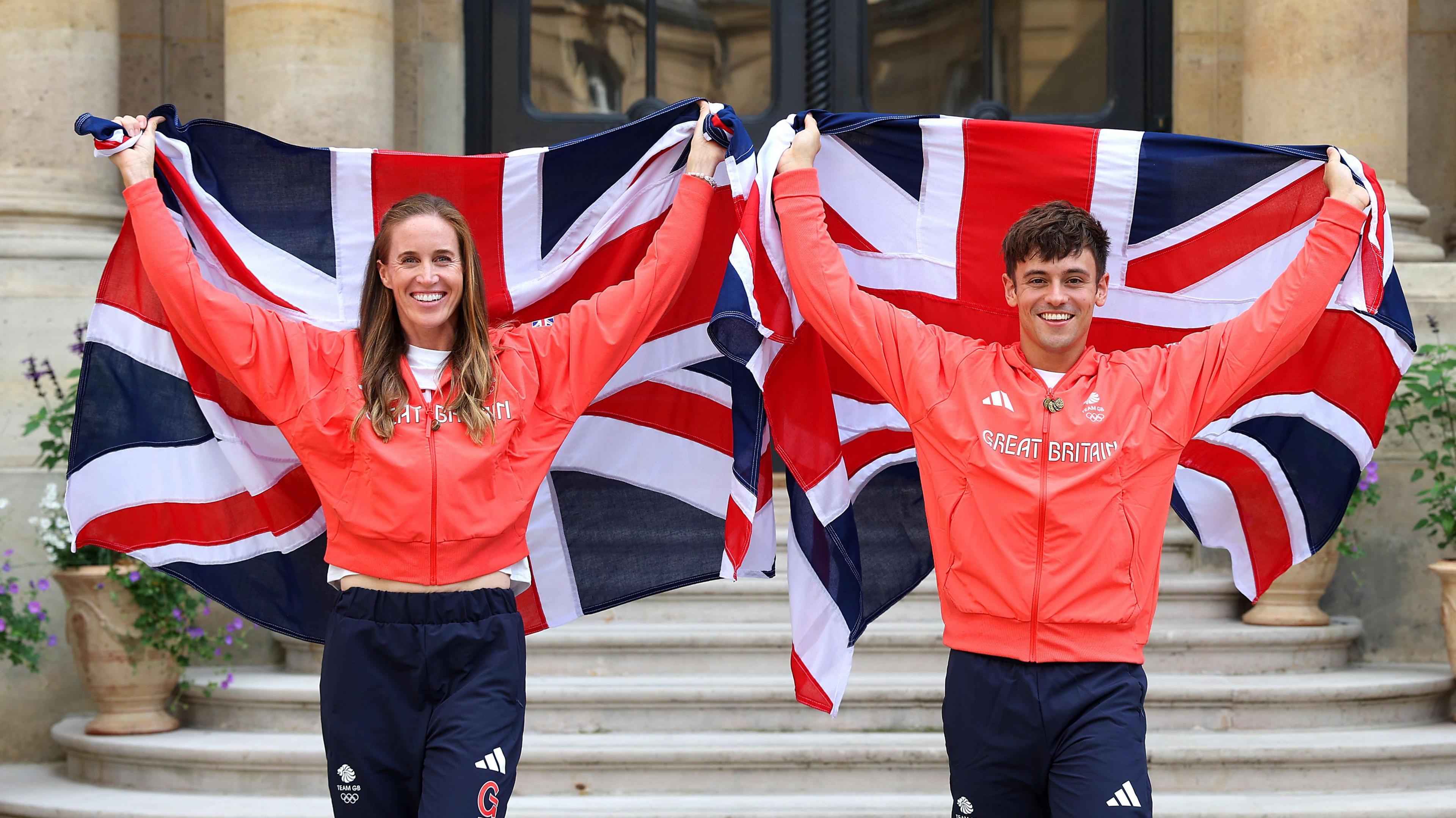 Helen Glover and Tom Daley of Team Great Britain pose for a photo with their national flags during the Team Great Britain Flagbearer photocall at British Embassy on July 24, 2024 in Paris.