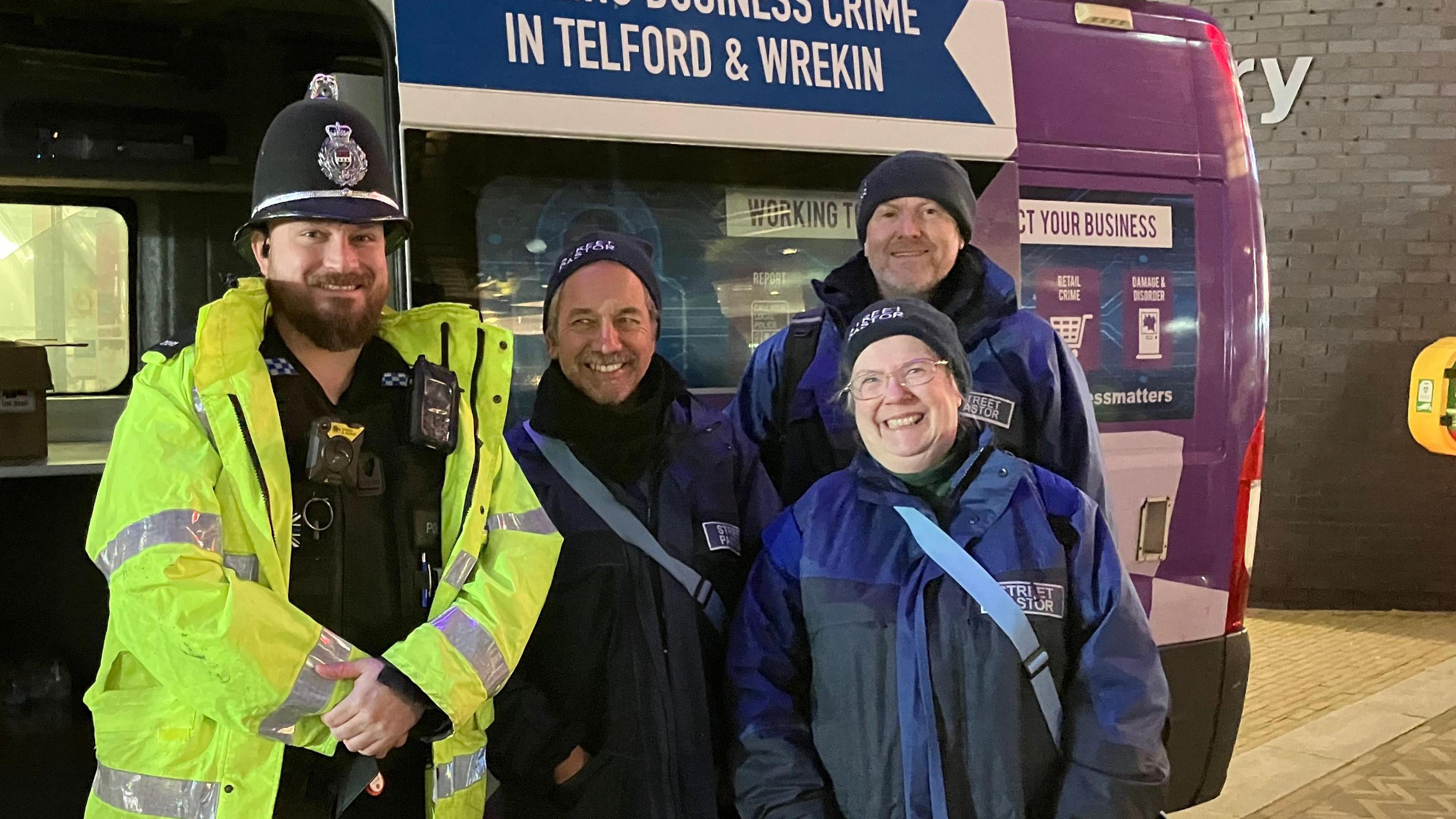 PC Ash Doignie standing with Telford Street Pastors Chris Hill, Simon Trotman and Julie Rotherham outside a police van in Southwater, Telford.  The police van will be used to support people on a night out.