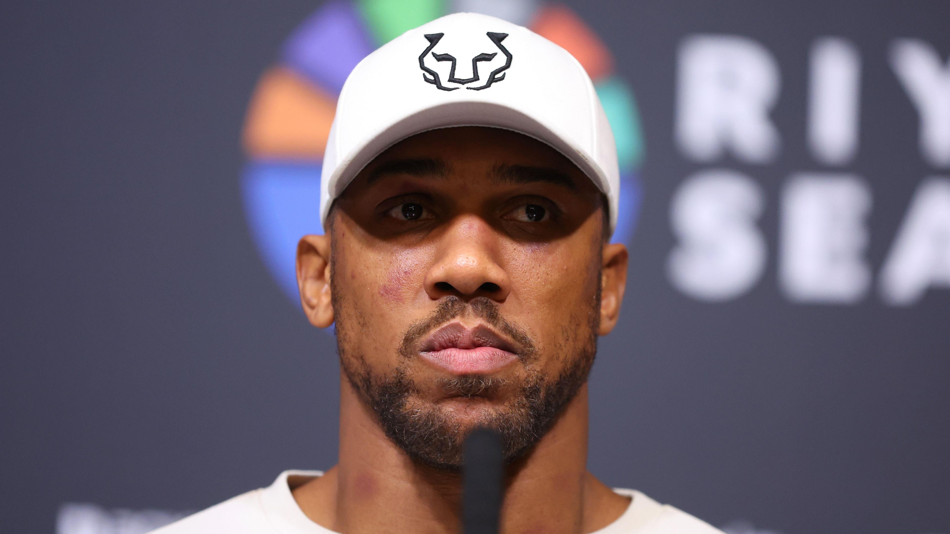 Anthony Joshua speaking at a press conference following his defeat by Daniel Dubois at Wembley.