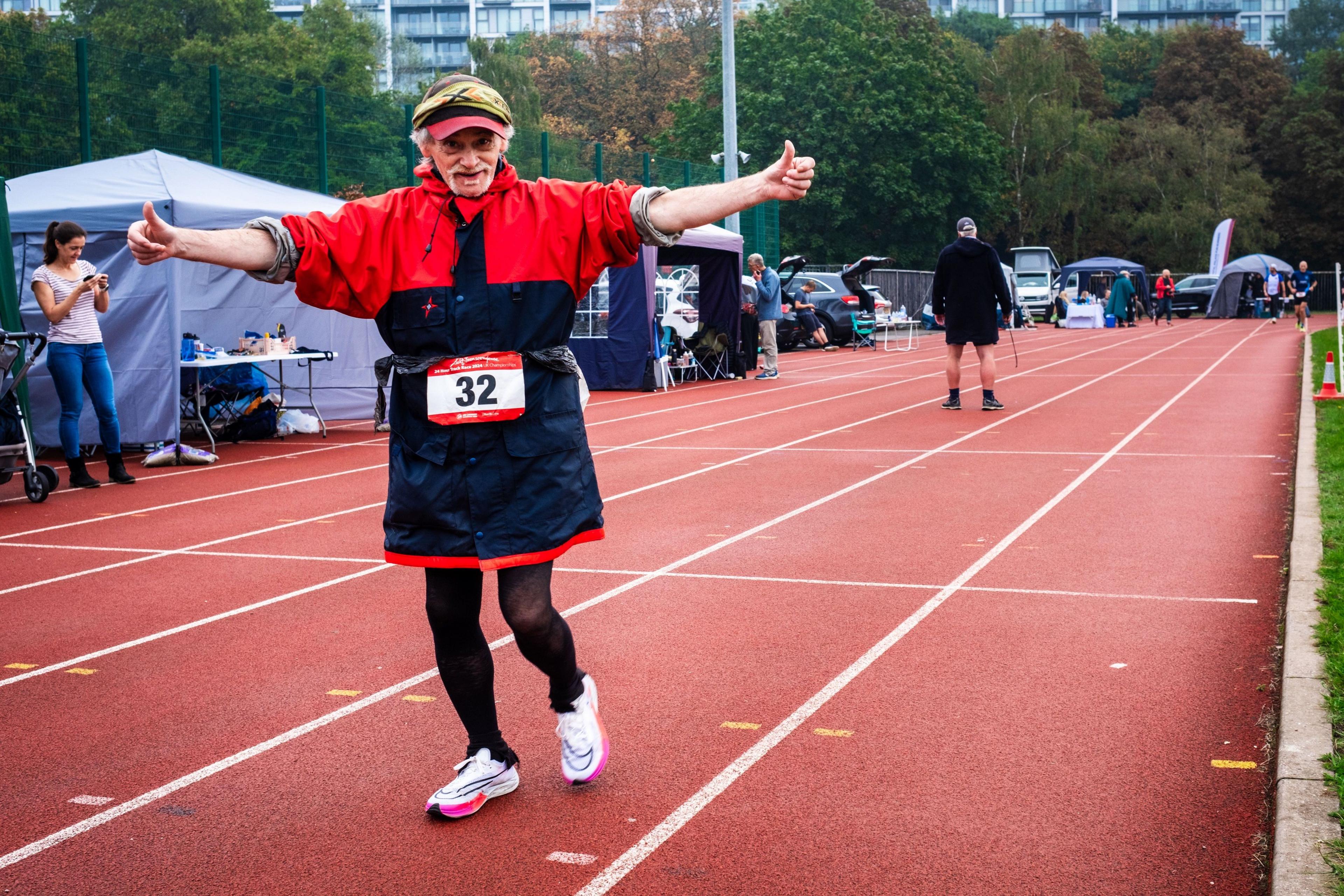 Ray McCurdle, 70, gives a thumbs-up as he competes in the Sri Chinmoy 24hr Track Race