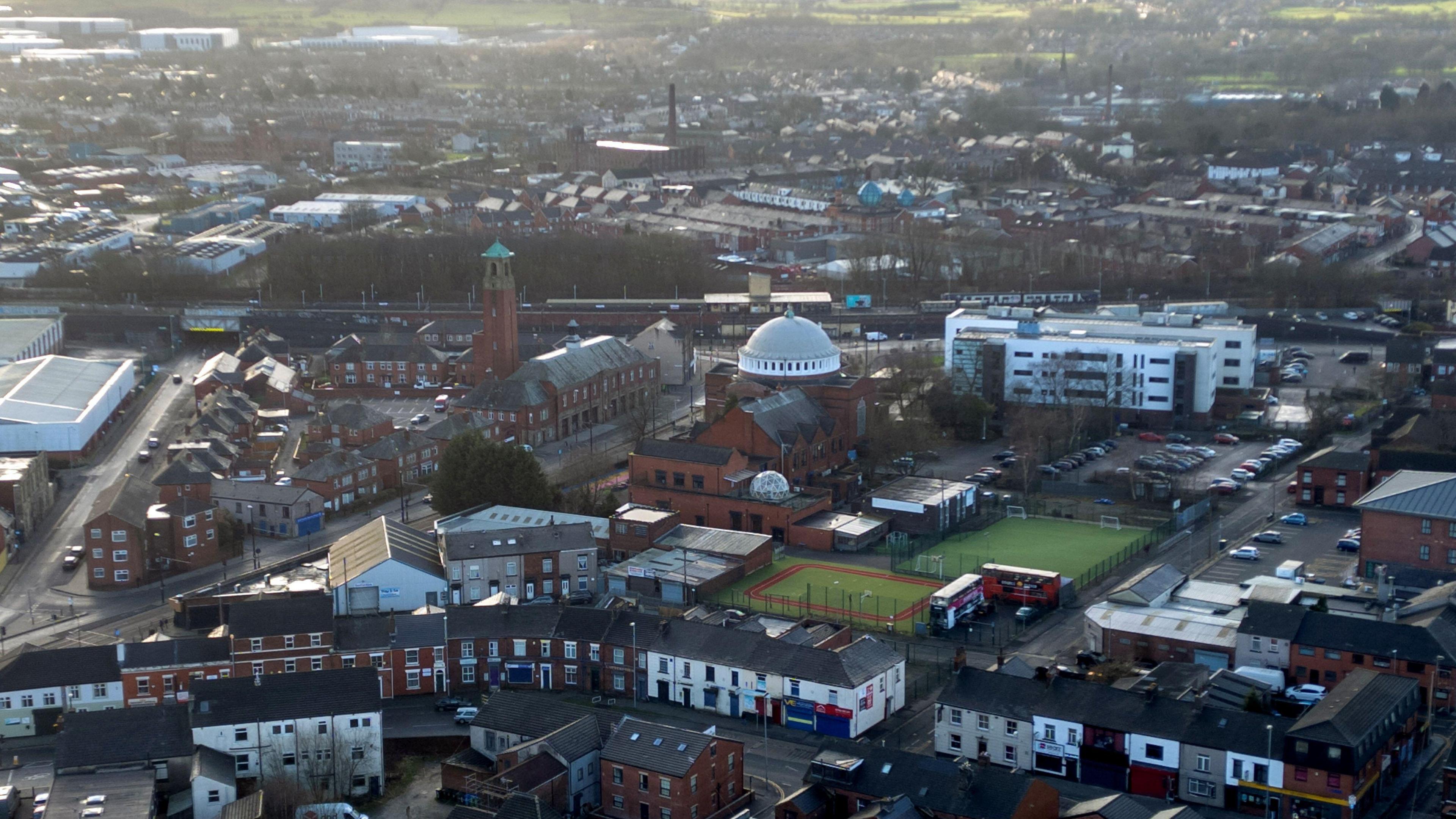 A drone view of terraced housing and the dome of St John the Baptist church in Rochdale. 