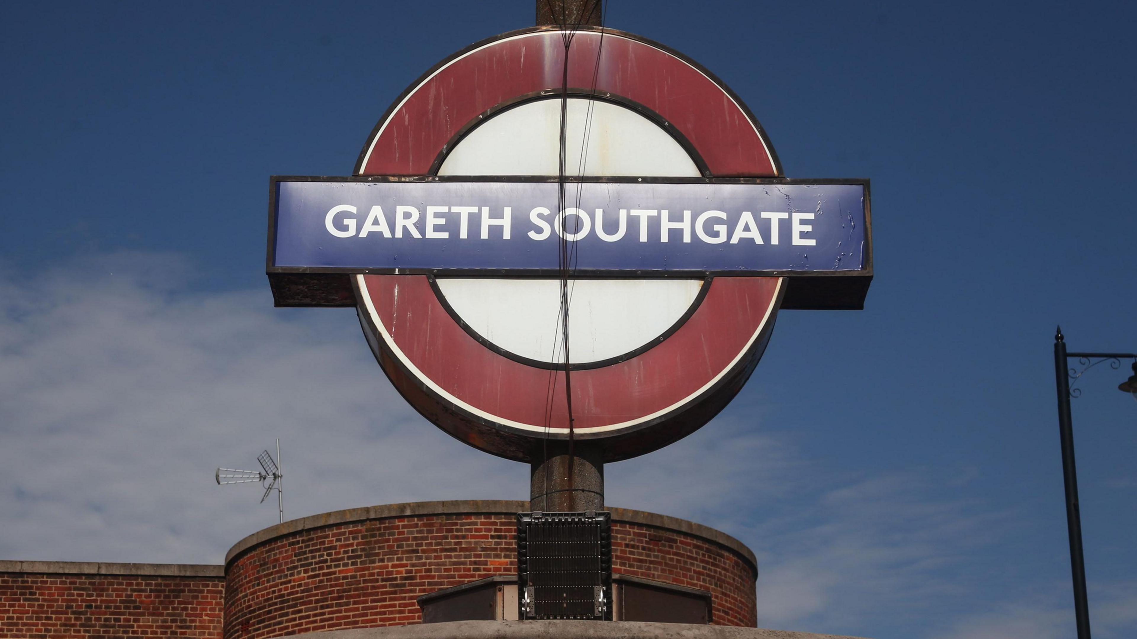 A Tube sign above a 1930s brick station - it says Gareth Southgate.