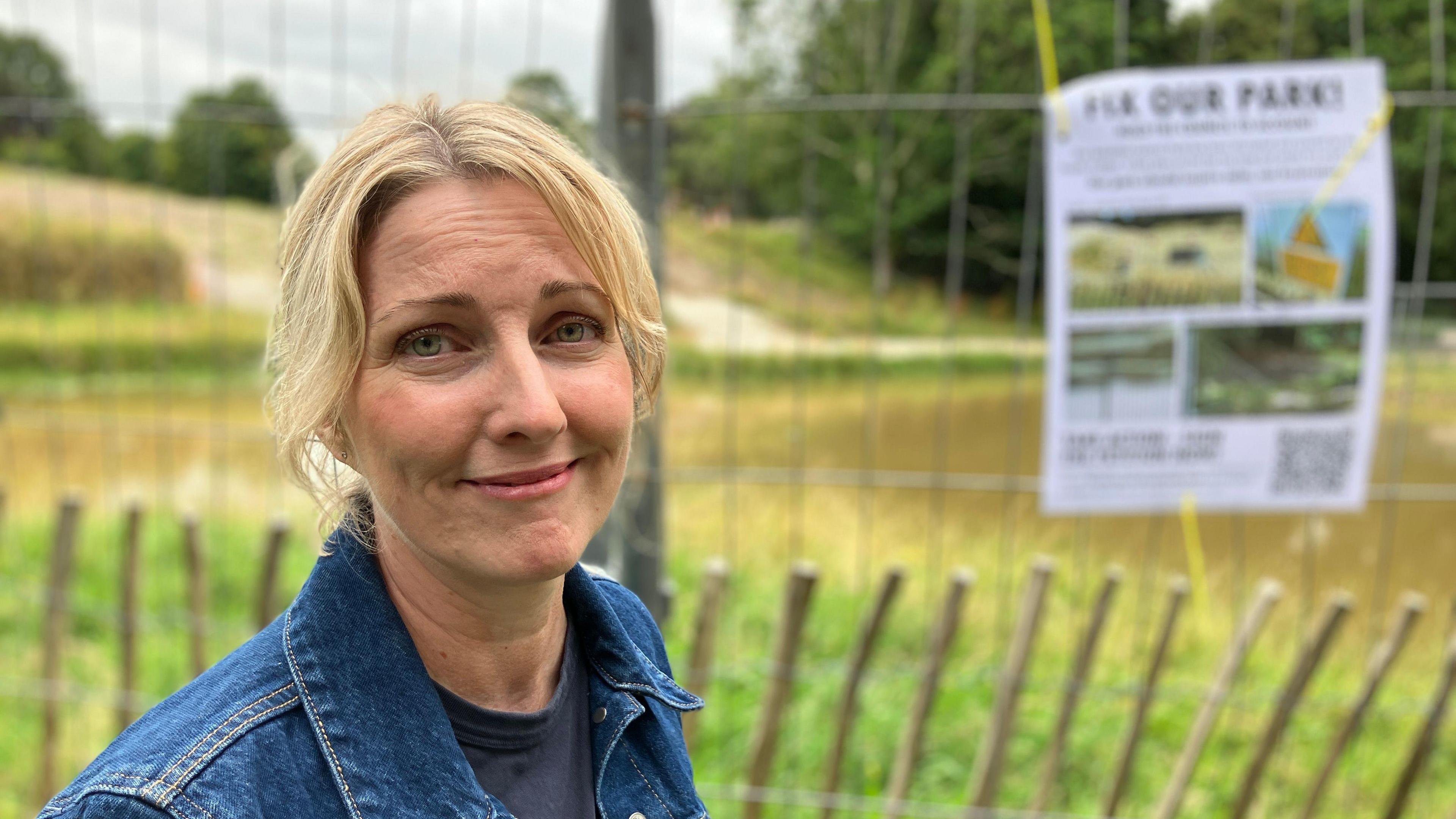 Amanda Pannell standing in front of a fenced-off area of the park