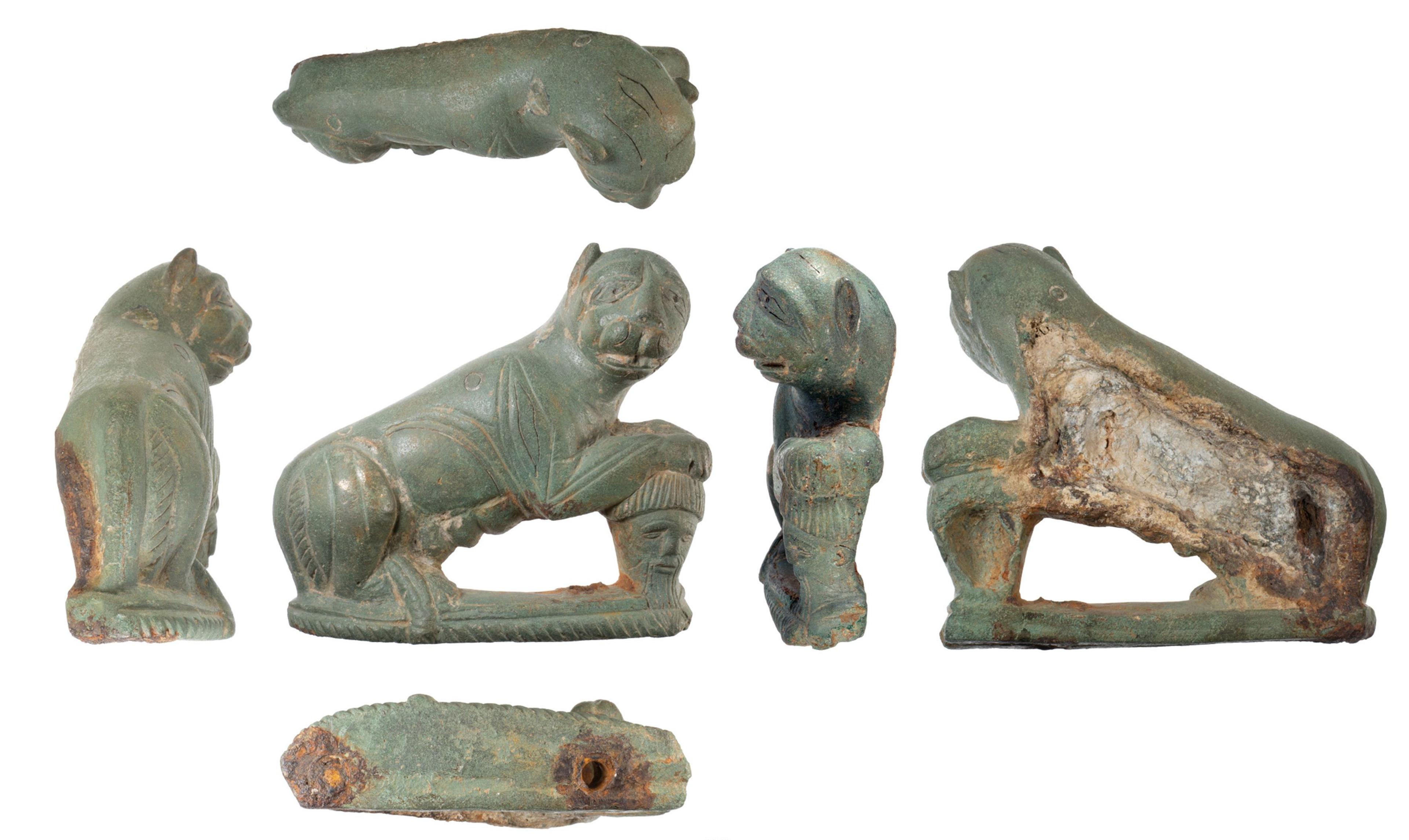 Different shots of Roman vehicle fittings - that look like an animal- displayed on a white background