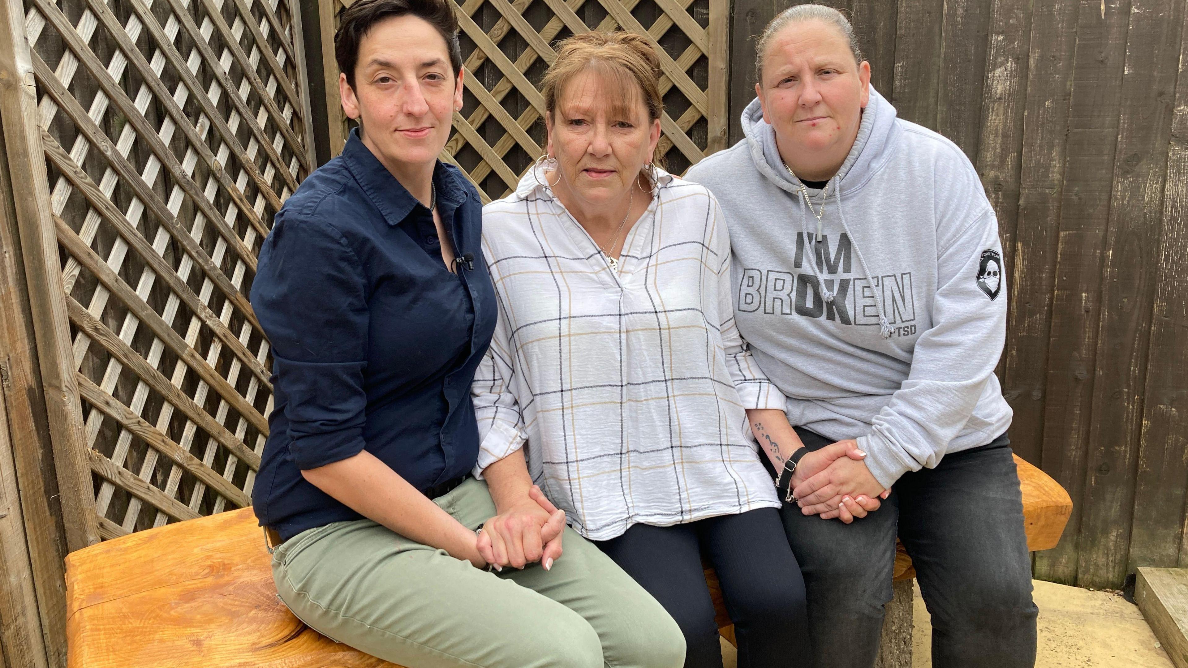 Mr Waddington's sisters and his mum sitting on the bench