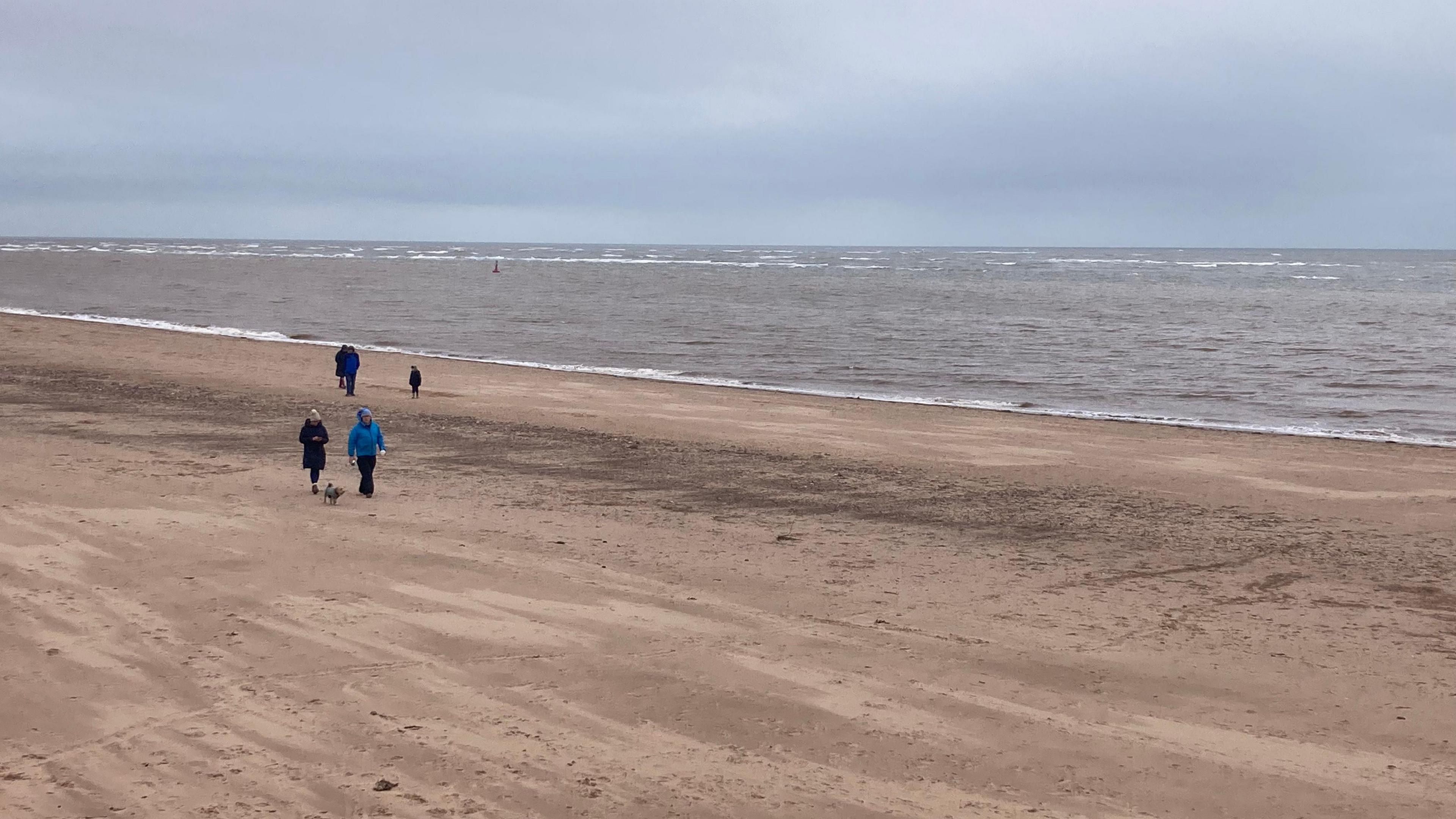 General view of Exmouth beach with people walking 