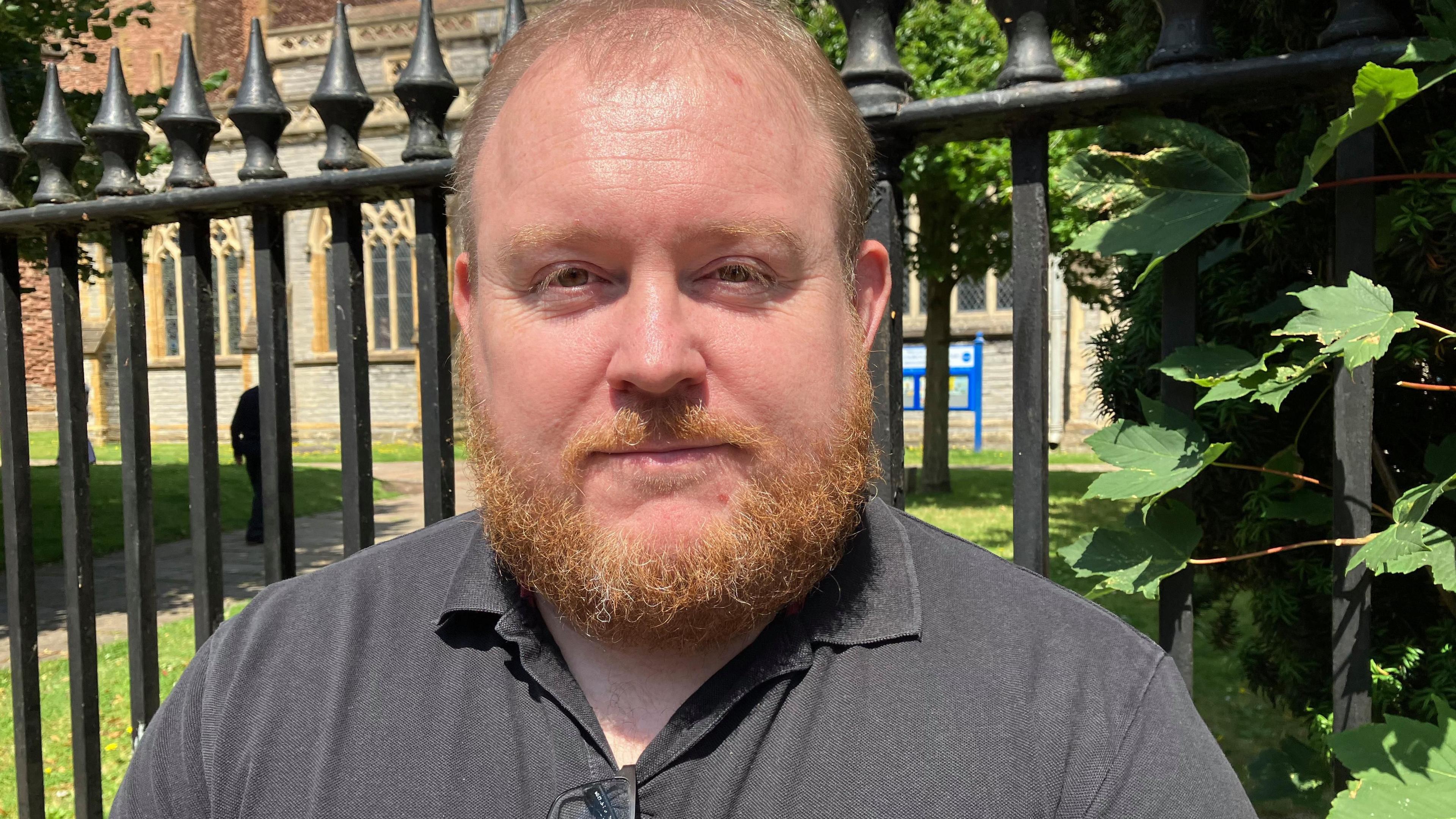 a man in front of some railings