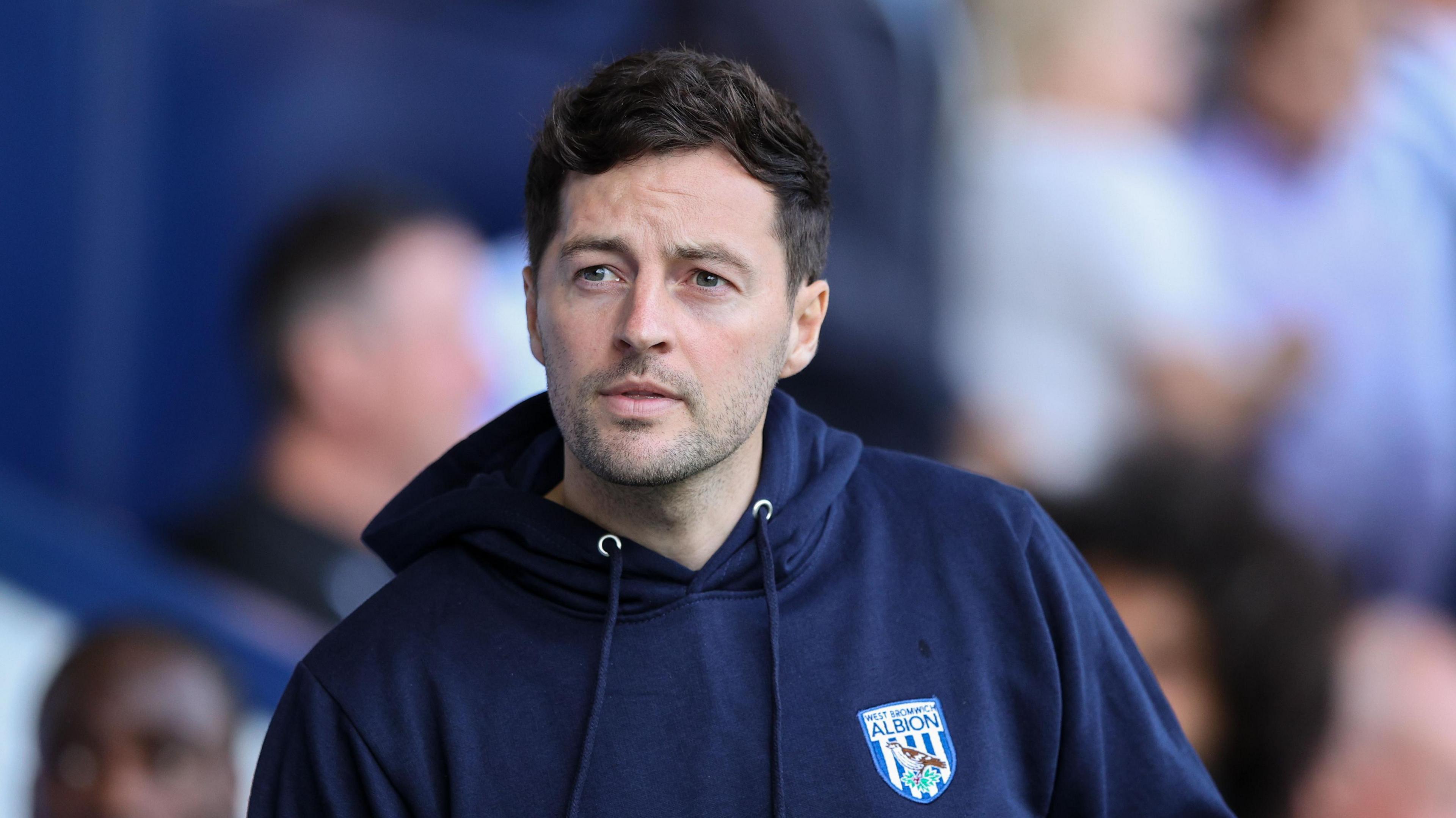 Ryan Mason wearing a West Brom navy hoodie at The Hawthorns during the Blackburn match