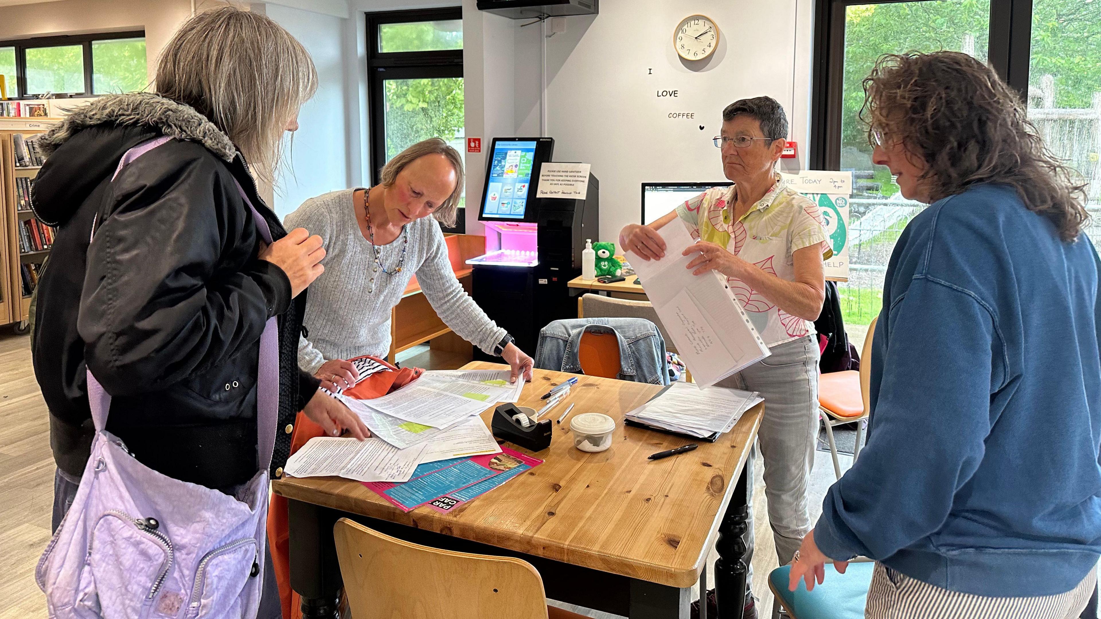 People looking at paperwork on a table