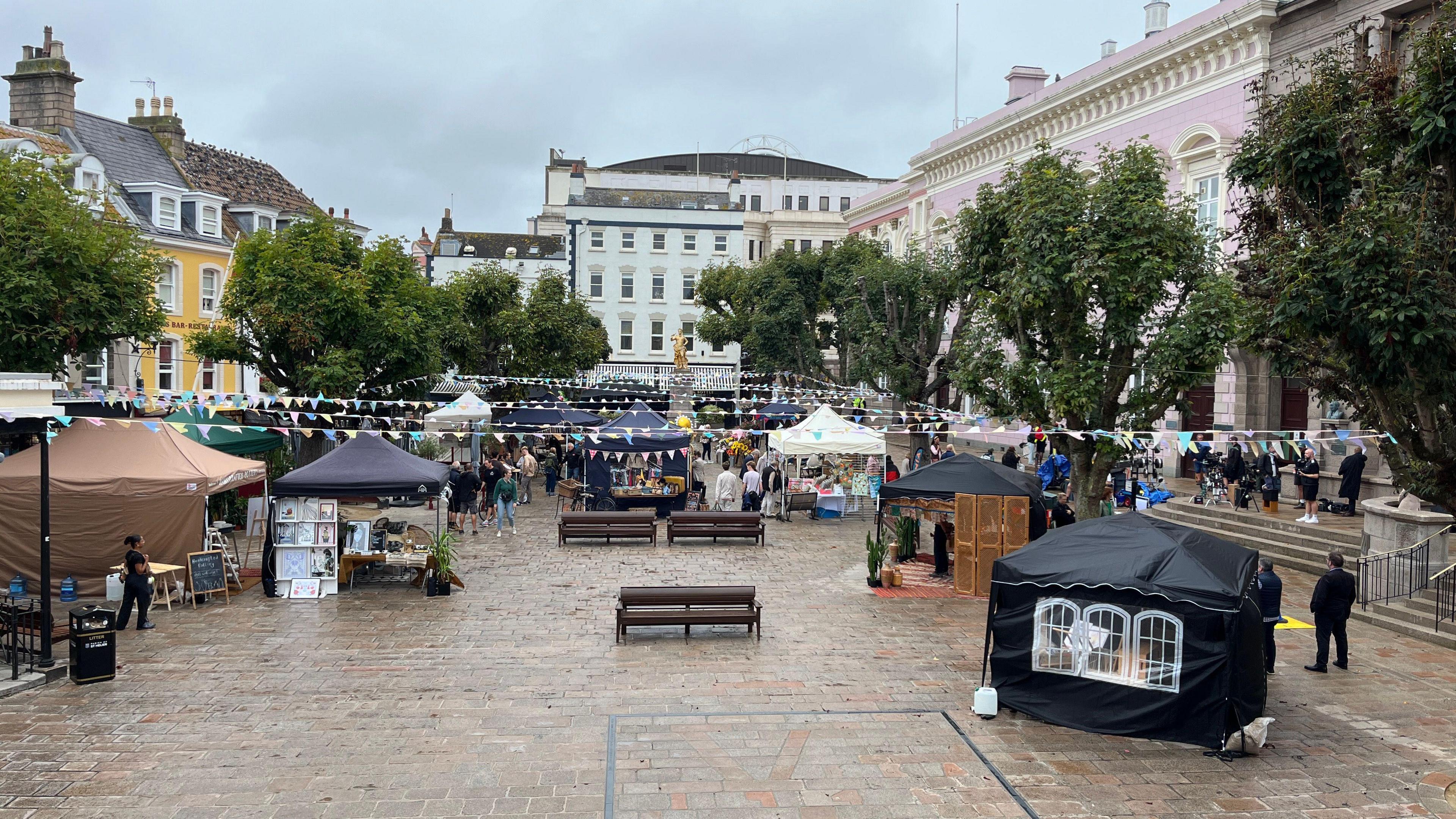 A view of Jersey Market Square with various set pieces and tents