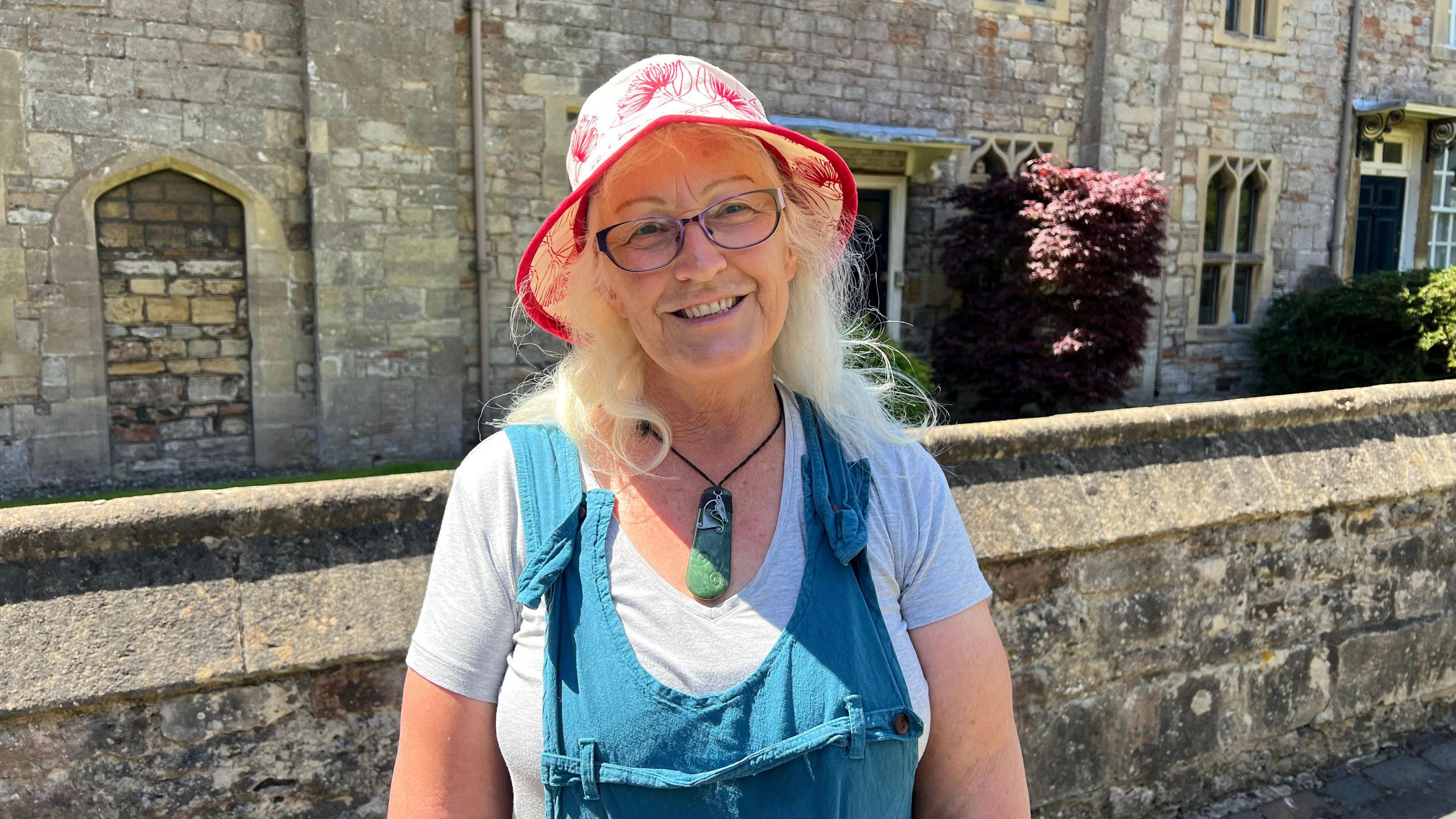 Debbie from New Zealand standing in the sunshine in the centre of Wells in Somerset