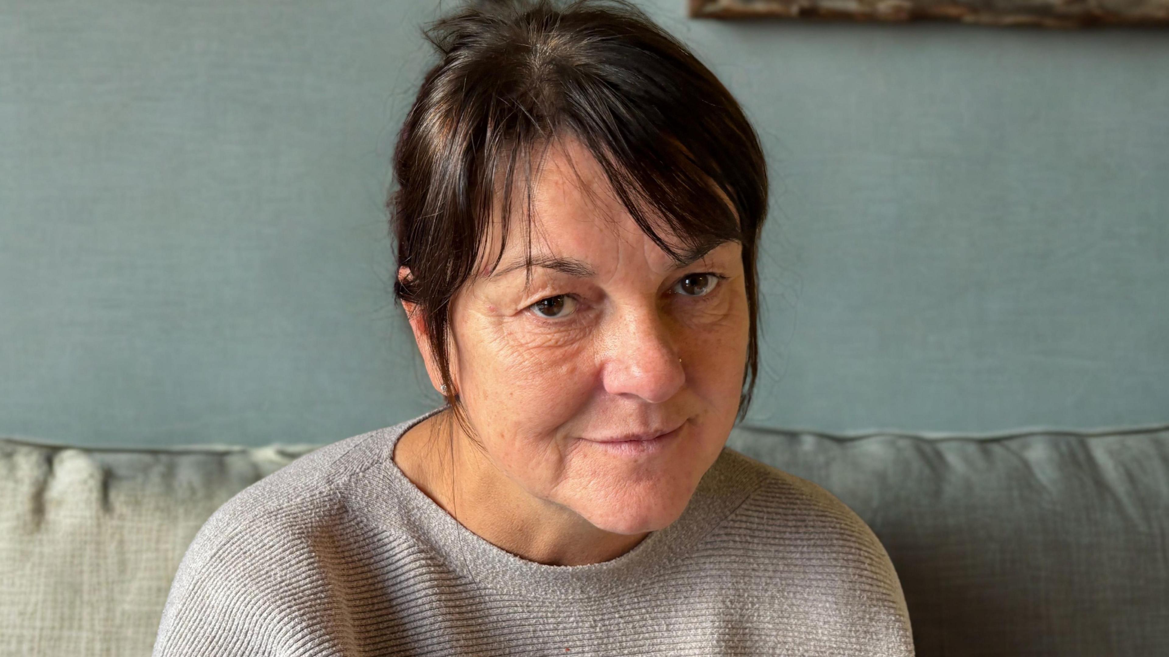 Erica Hay, a middle-aged woman with dark hair.