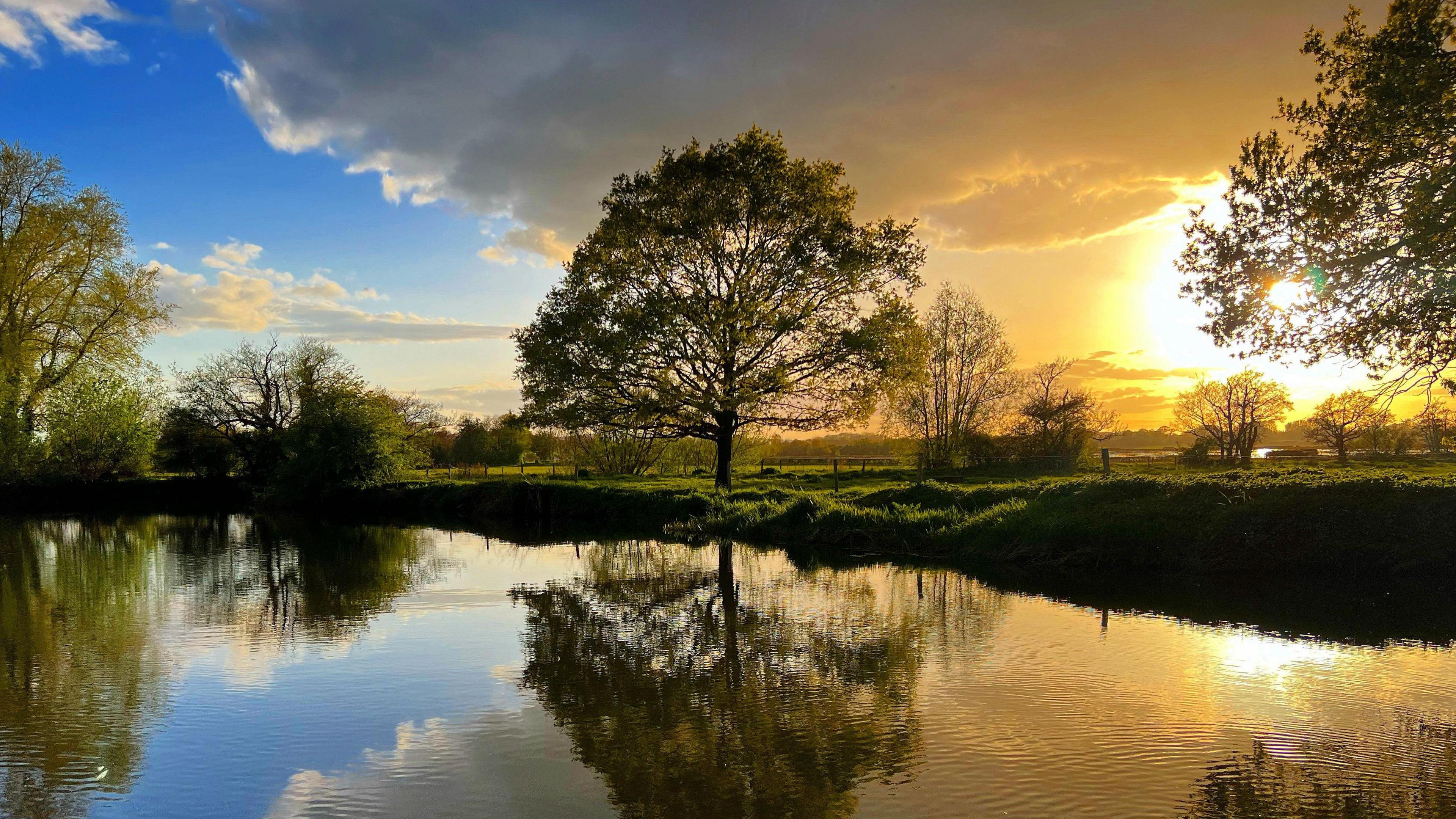 The sun reflecting on water in Barcombe Mills