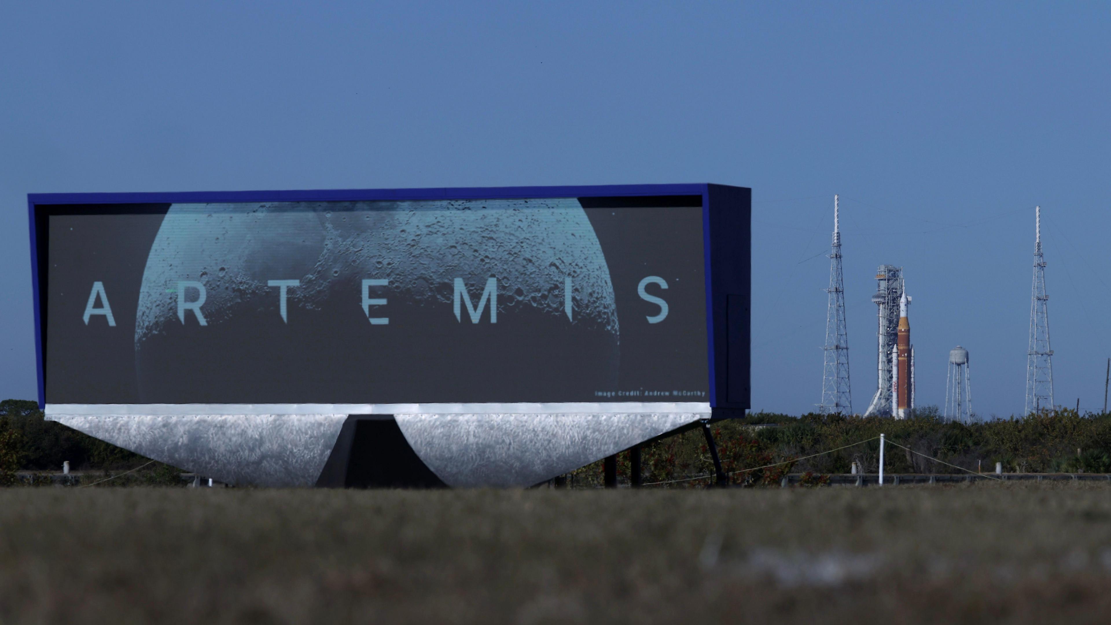 A large sign reading Artemis with a rocket in the background