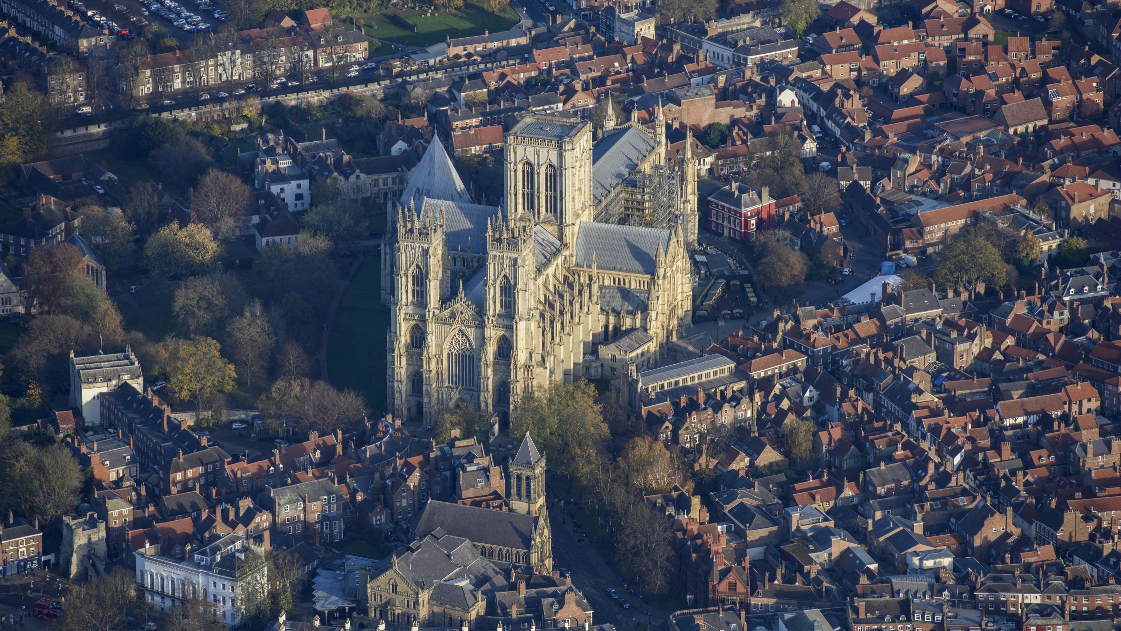 An aerial view of York Minster, in amongst houses and properties in the surrounding area