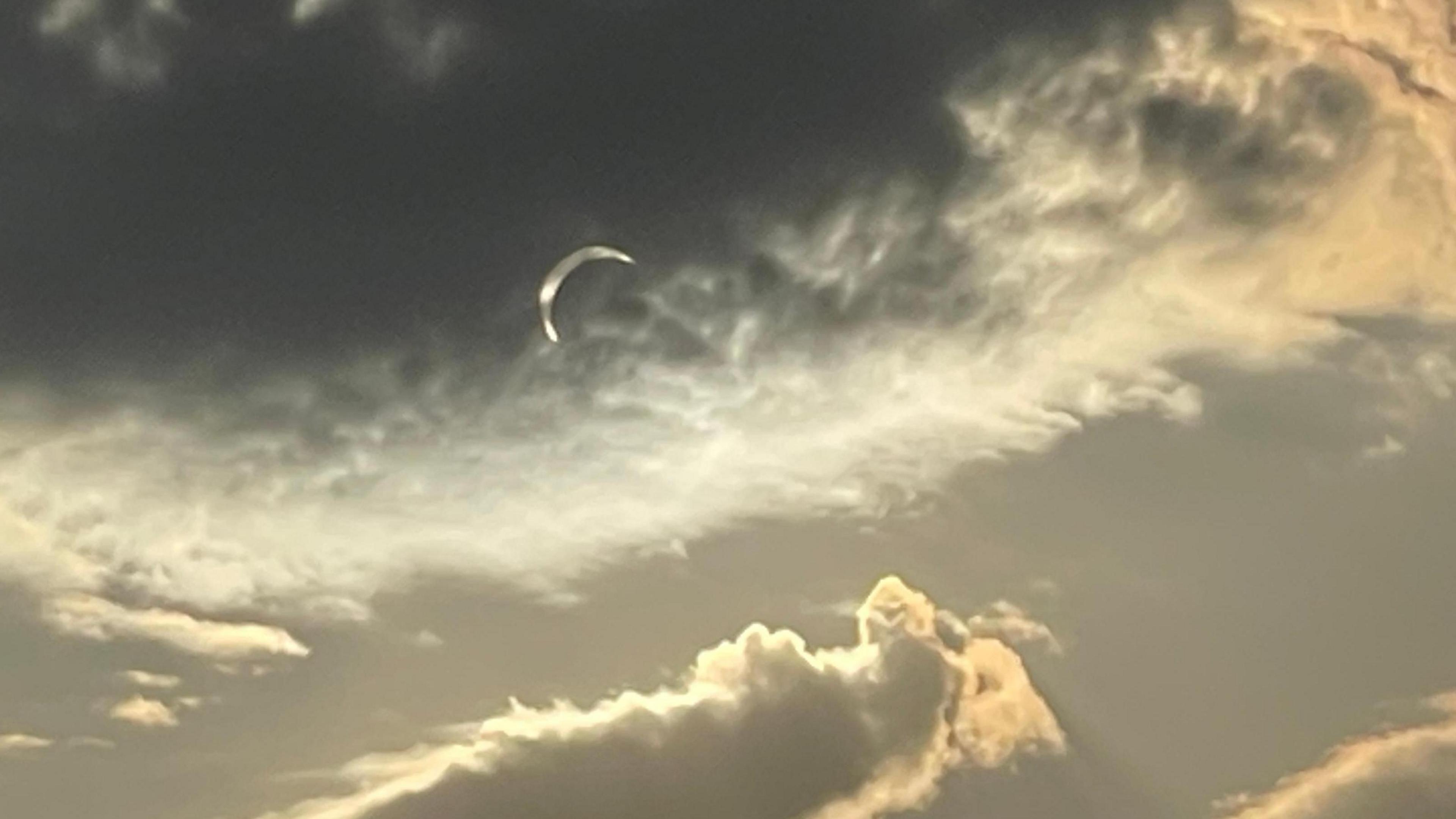 Cloudy sky reveals partial eclipse