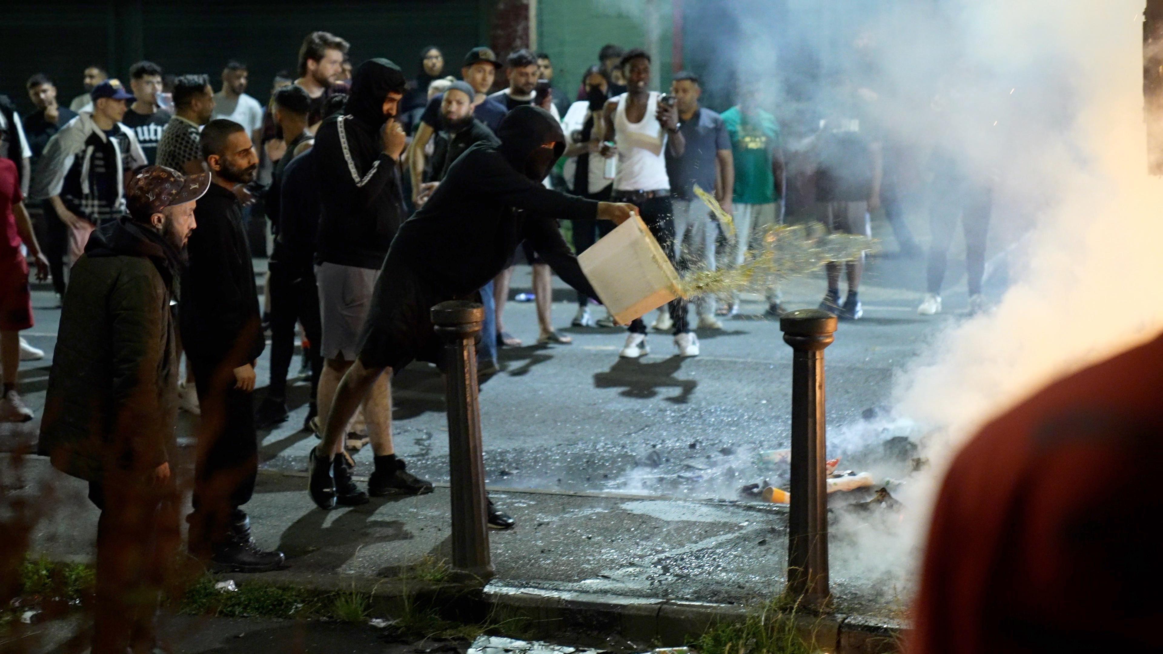 A man throws water over a fire