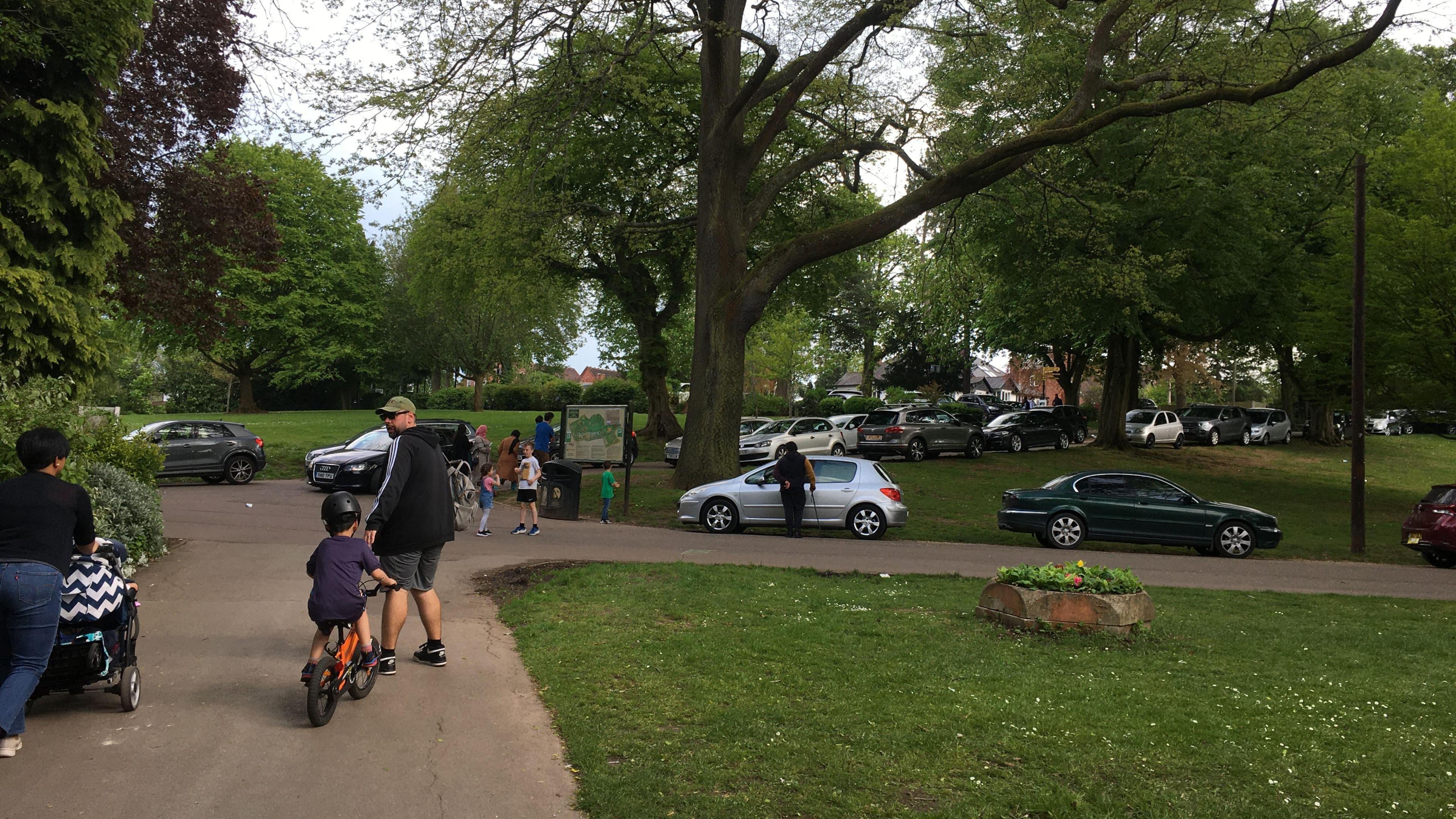 Children playing while cars parked in park