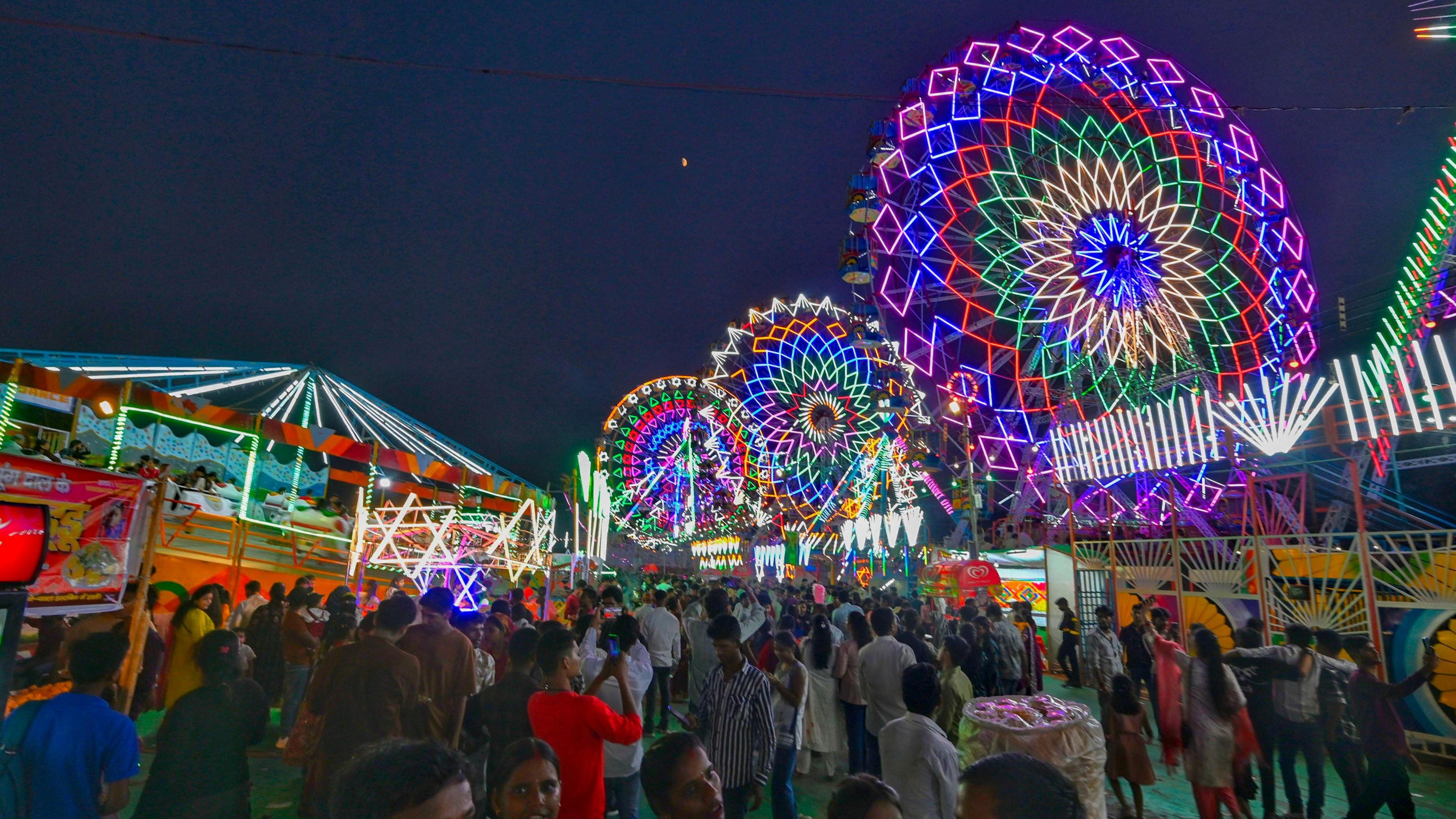 View of illuminated Ferris wheels, swings and shops at Ramlila mela (fair) in front of Red Fort Ground on the eve of the Dussehra festival on October 1, 2025 in New Delhi, India.