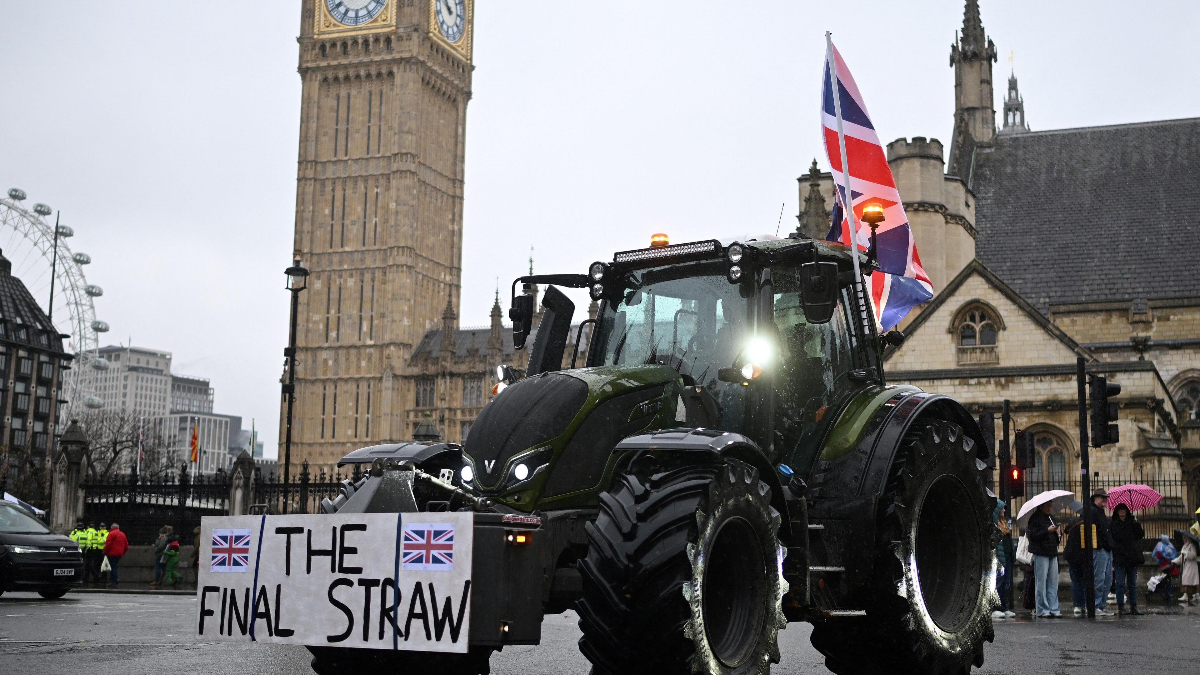 A farmer waves a Union flag from their cab as they drive a tractor past the Houses of Parliament, during a protest against inheritance tax rules for land ownership, in London. Big Ben is in the background.