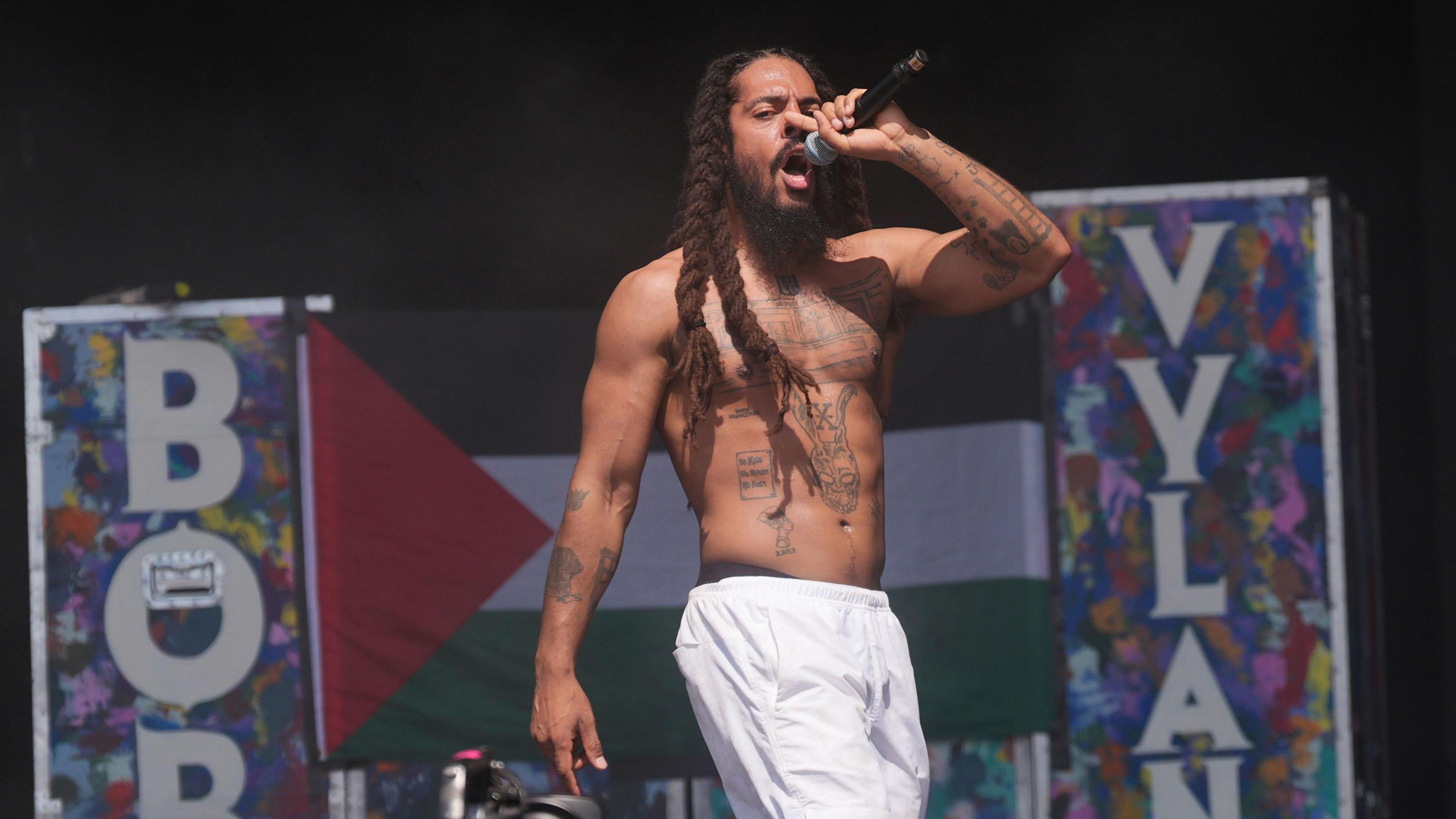 Bob Vylan's Bobby Vlan sings on the West Holts stage at Glastonbury