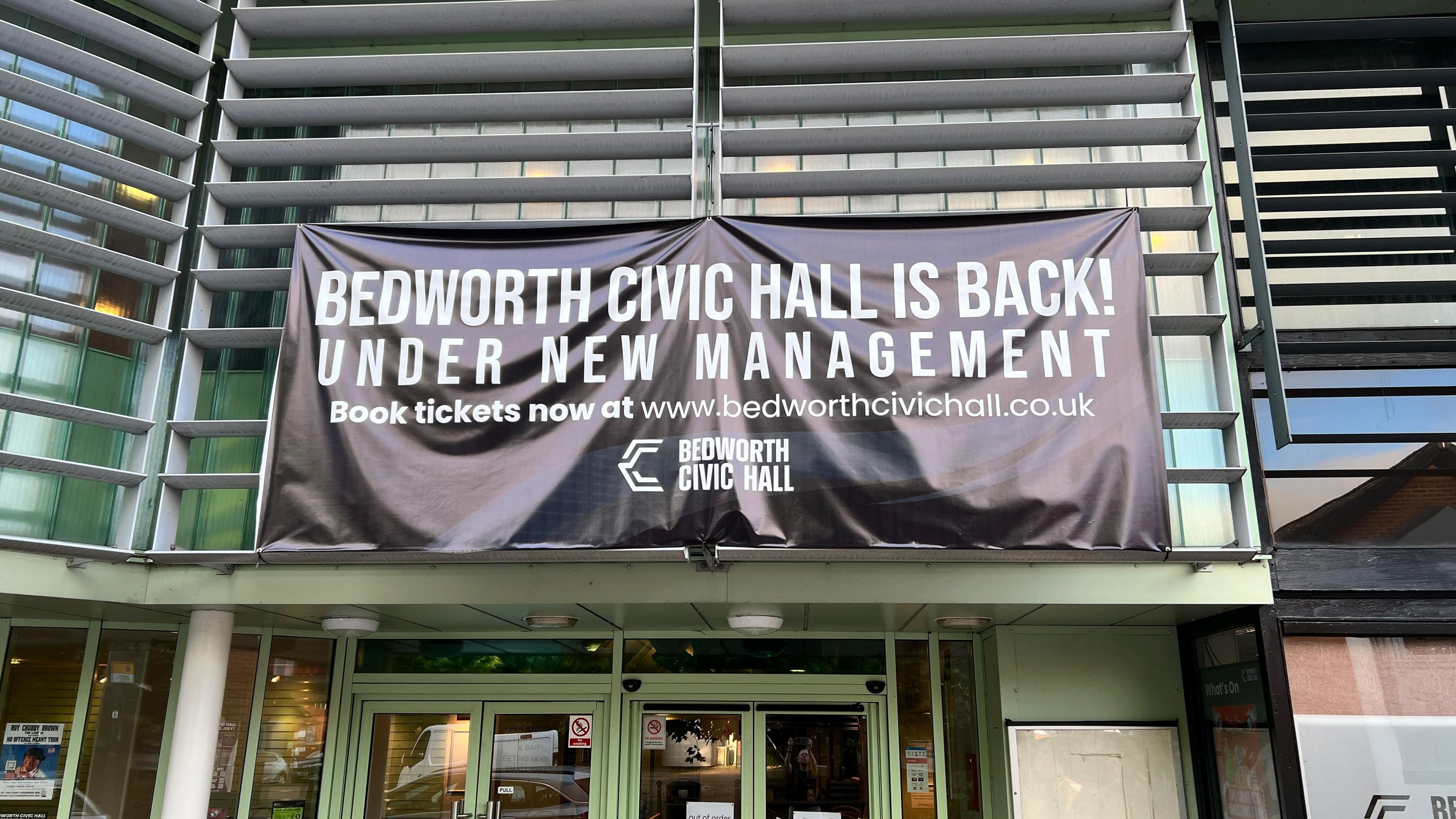 Glass and white building with civic hall is back banner