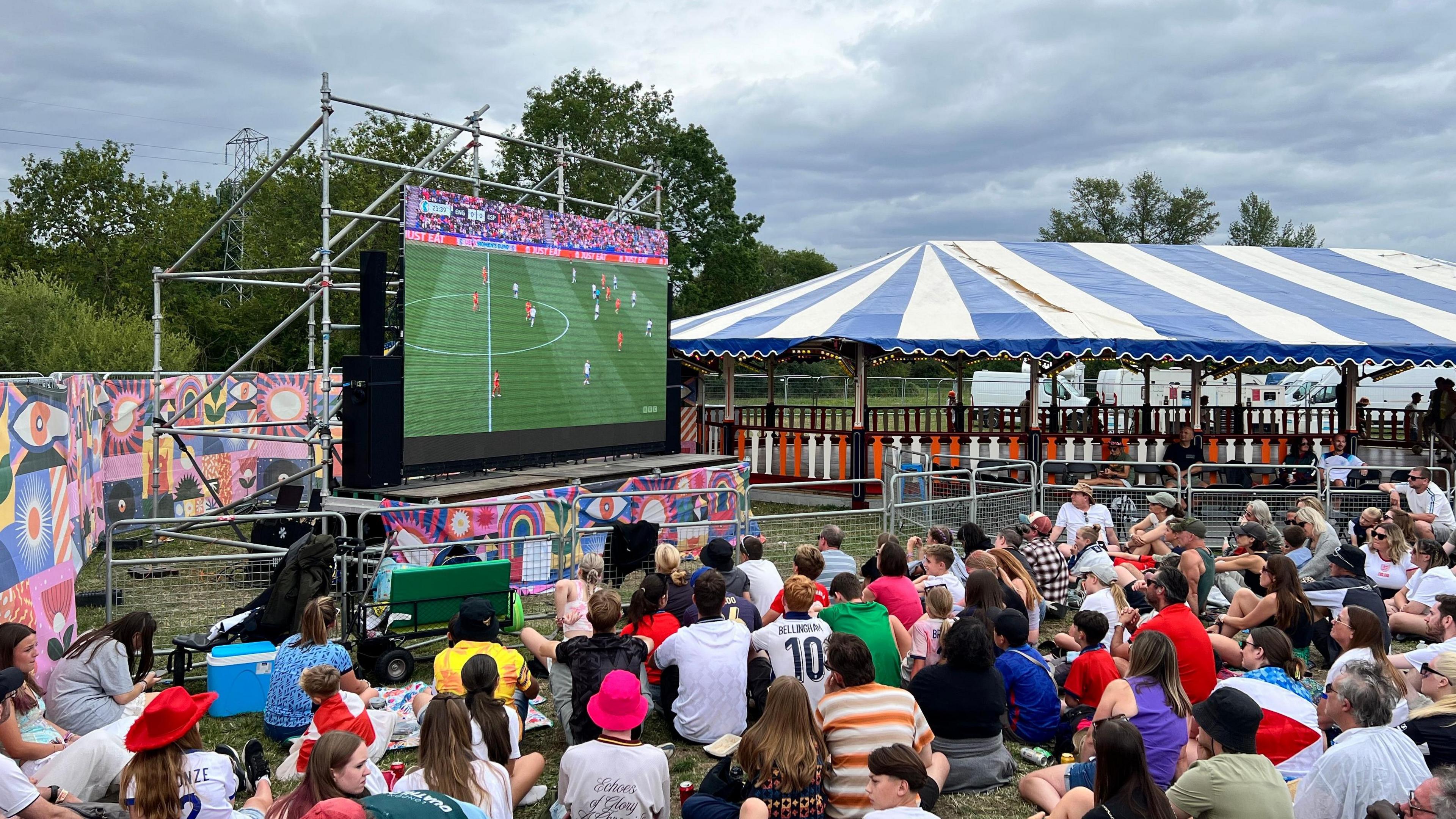 Festival goers watching the Lionesses play in the European Championship on a big screen at the festival.