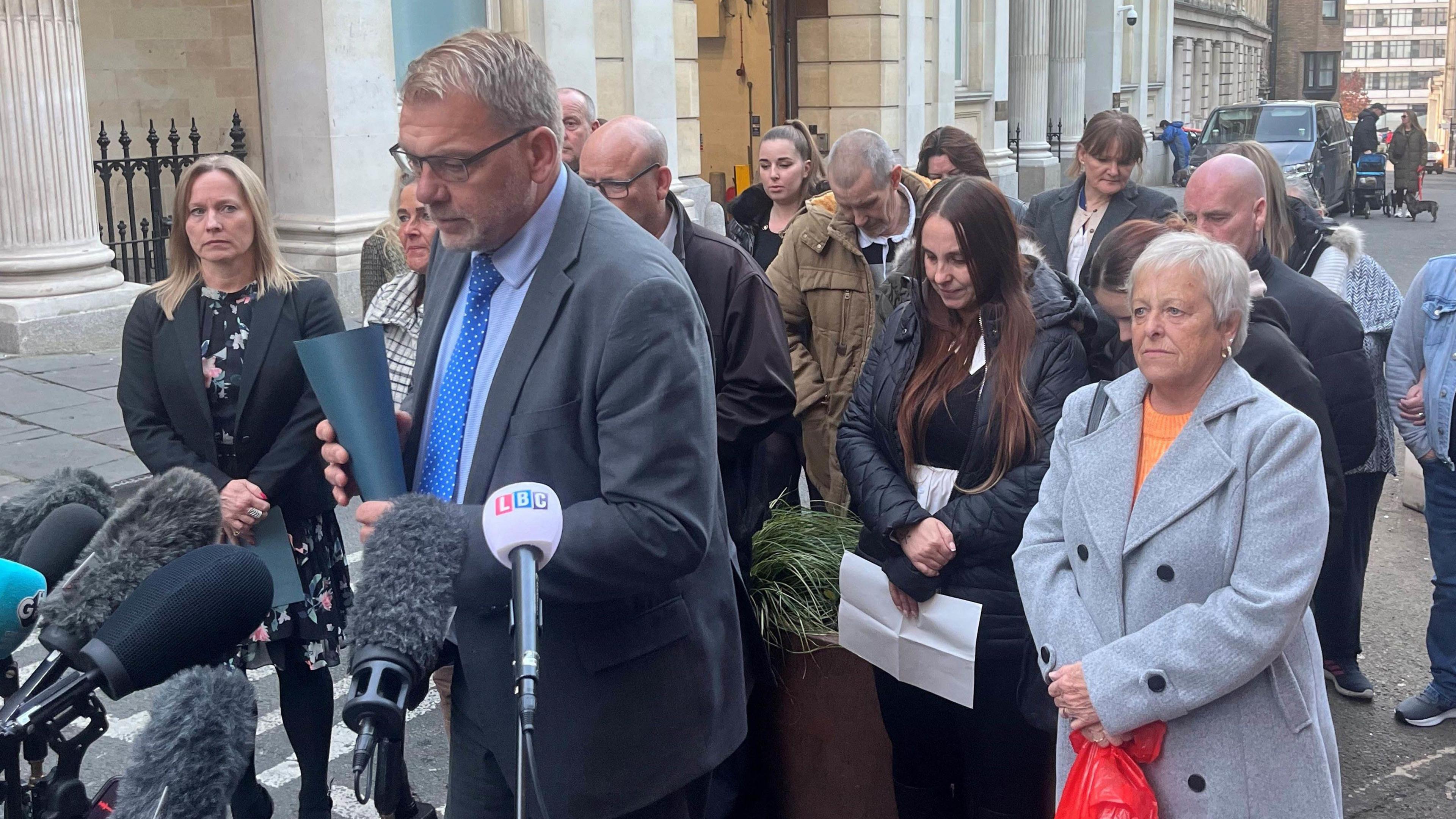 Detective Superintendent Gary Haskins talking to the media outside of Bristol Crown Court. Behind him are Max and Mason's family who are listening intently.