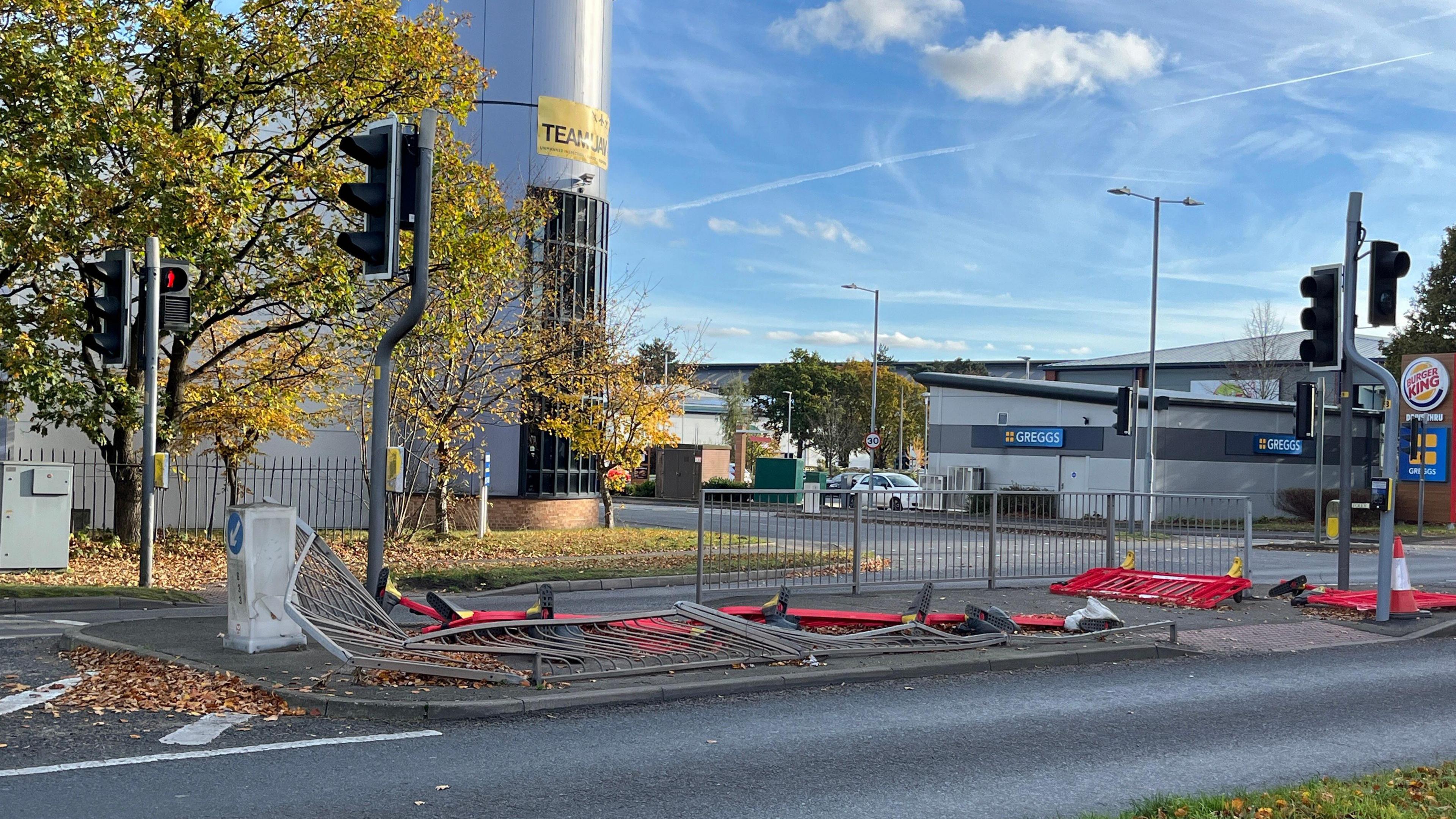 A traffic light junction with knocked over barriers 