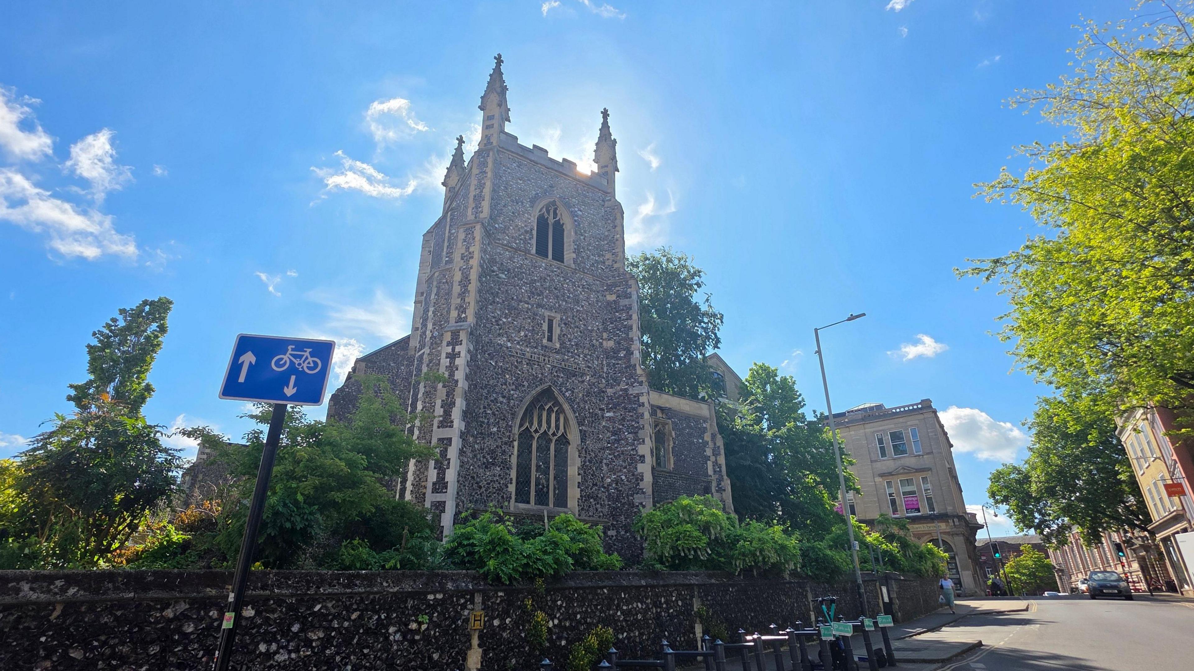 We can see the church on a sunny day, with three of the pinnacles on top of the tower visible.
