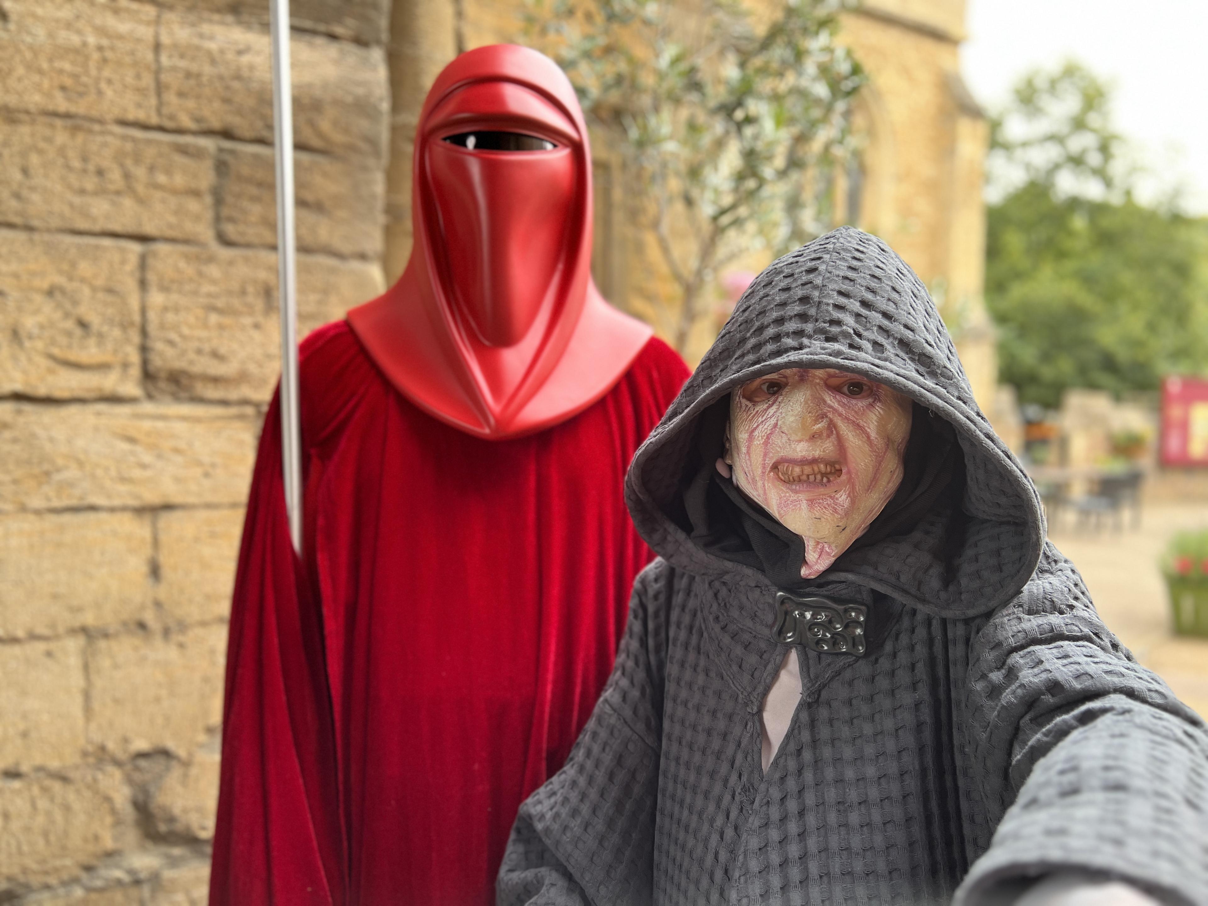 A Red Guard stands behind Emporer Palpatine