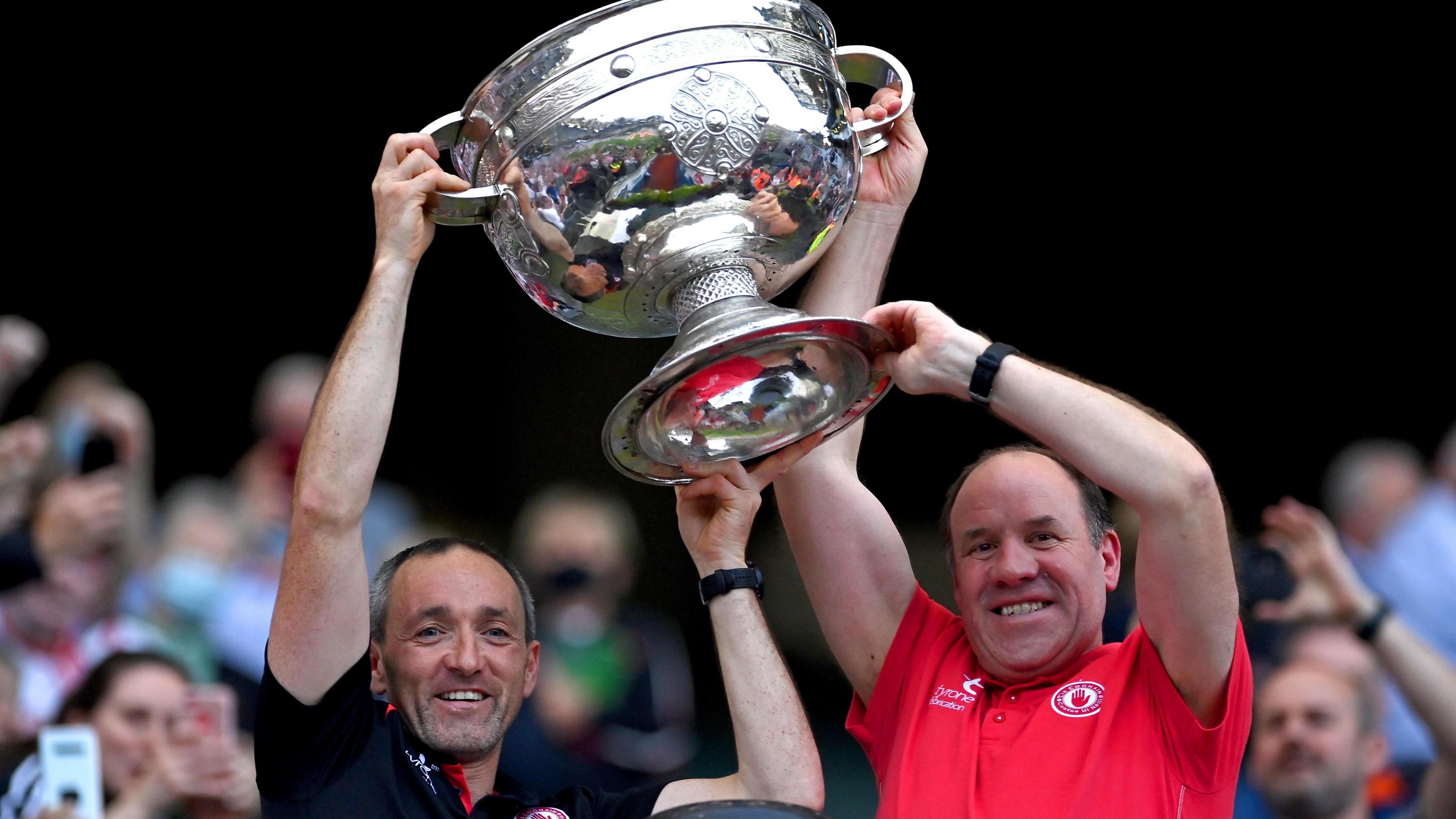 Tyrone joint-managers Brian Dooher, left, and Feargal Logan lift the Sam Maguire Cup after the GAA Football All-Ireland Senior Championship Final match between Mayo and Tyrone at Croke Park in Dublin. 