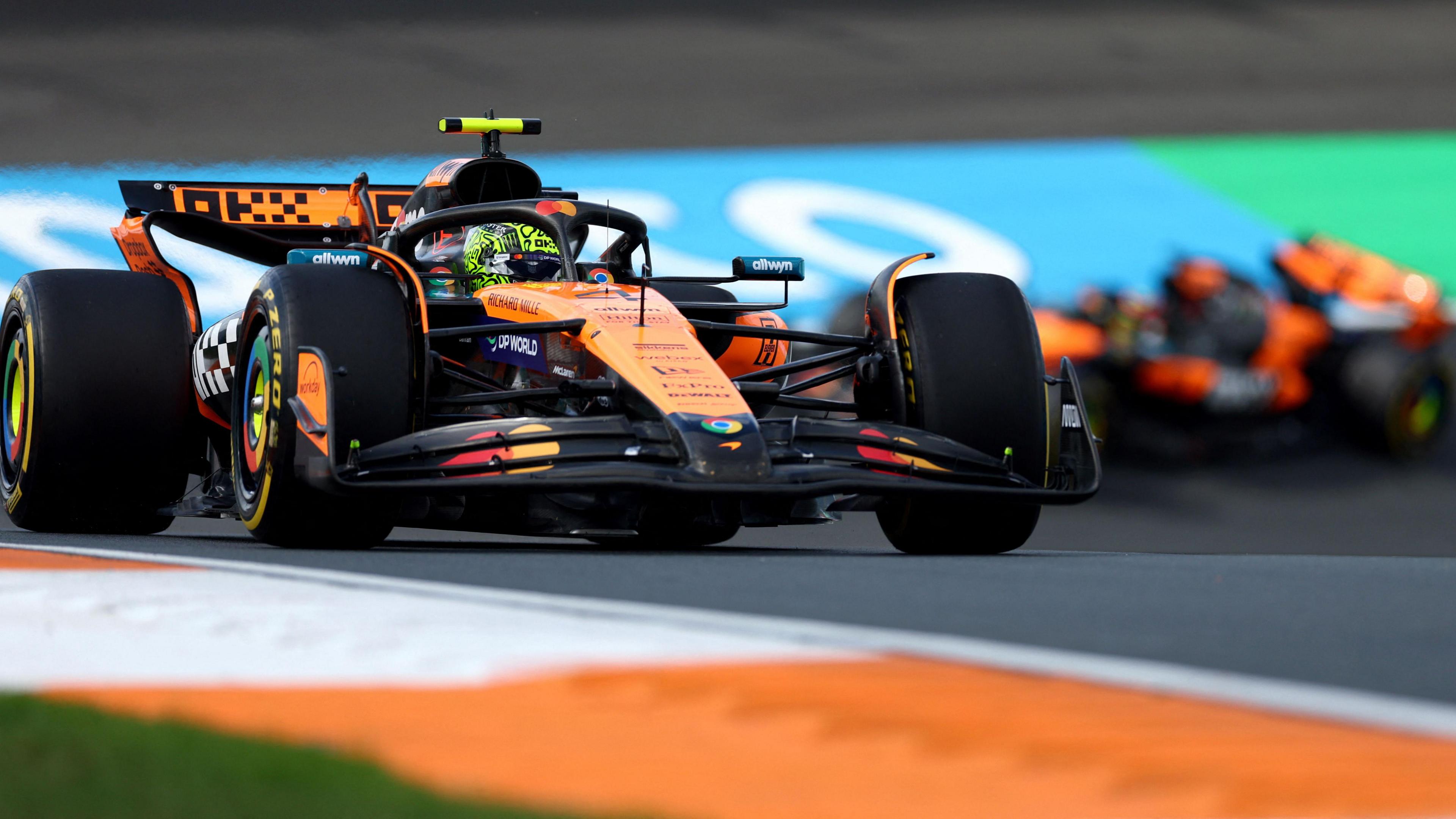 McLaren's Lando Norris in Dutch Grand Prix first practice with team-mate taking a corner in the background