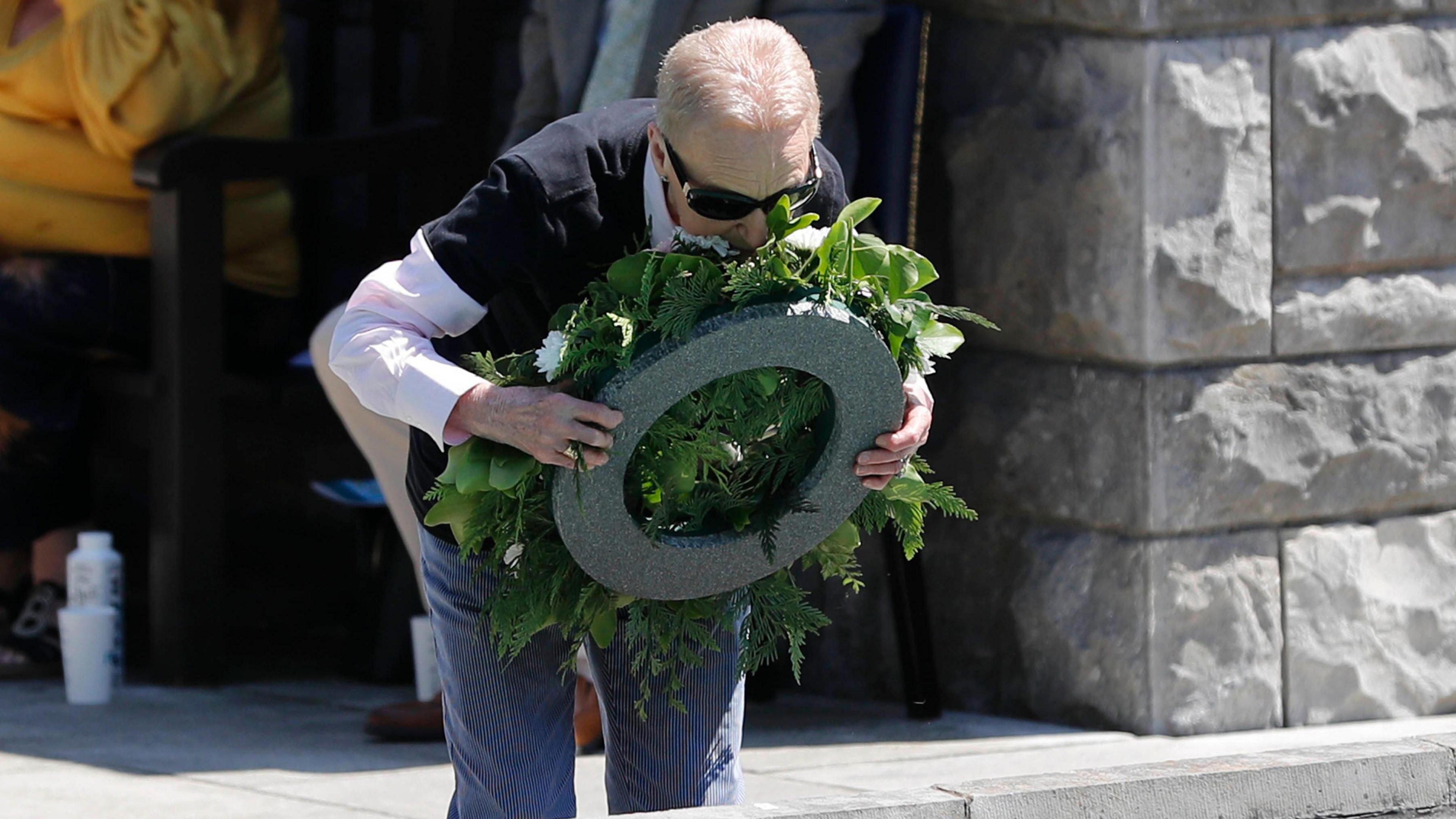 A woman kisses a wreath at the Garden of Remembrance in Dublin