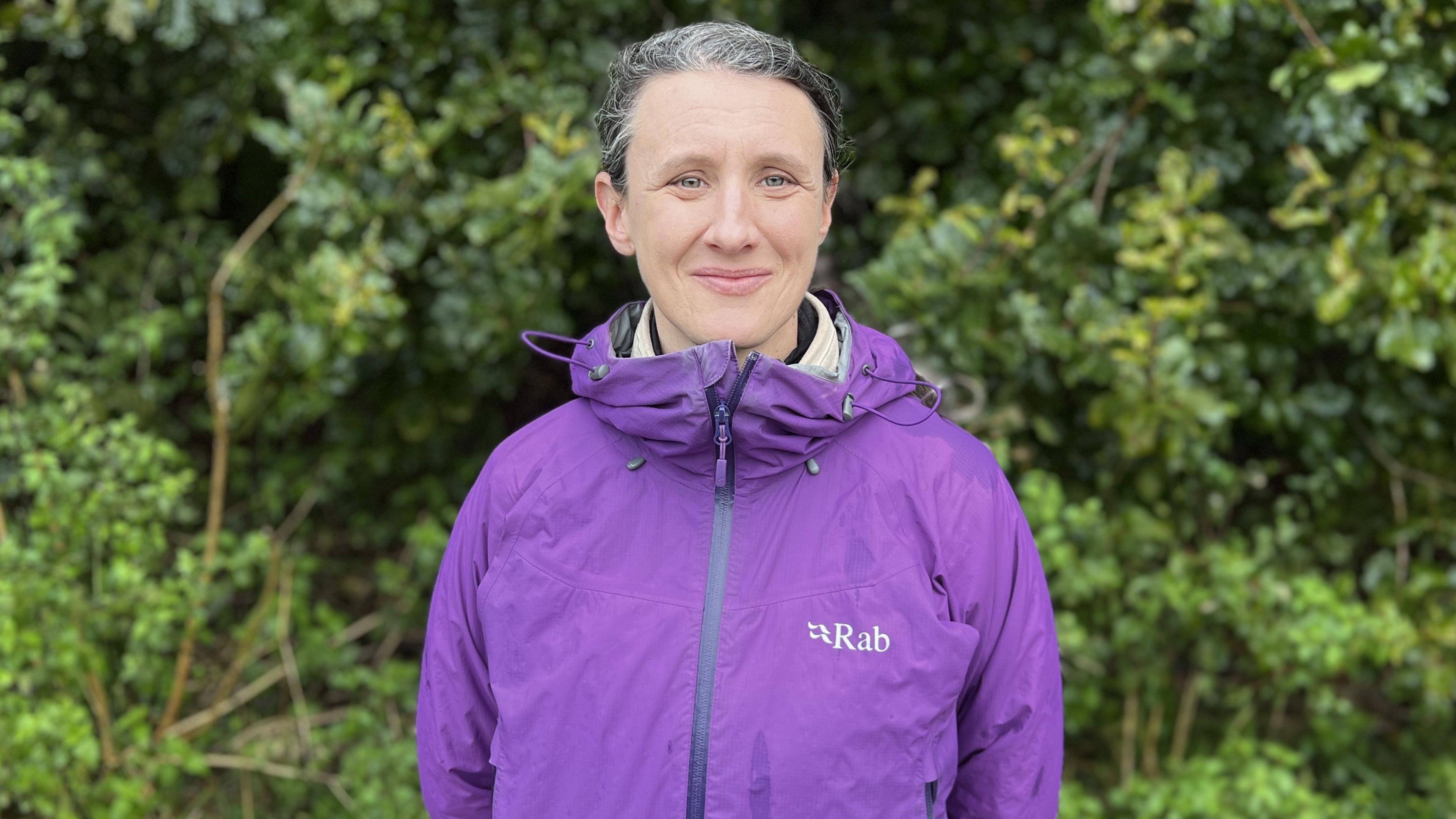 Cllr Emma Bushell at Nightingale Woods wearing a purple rain jacket