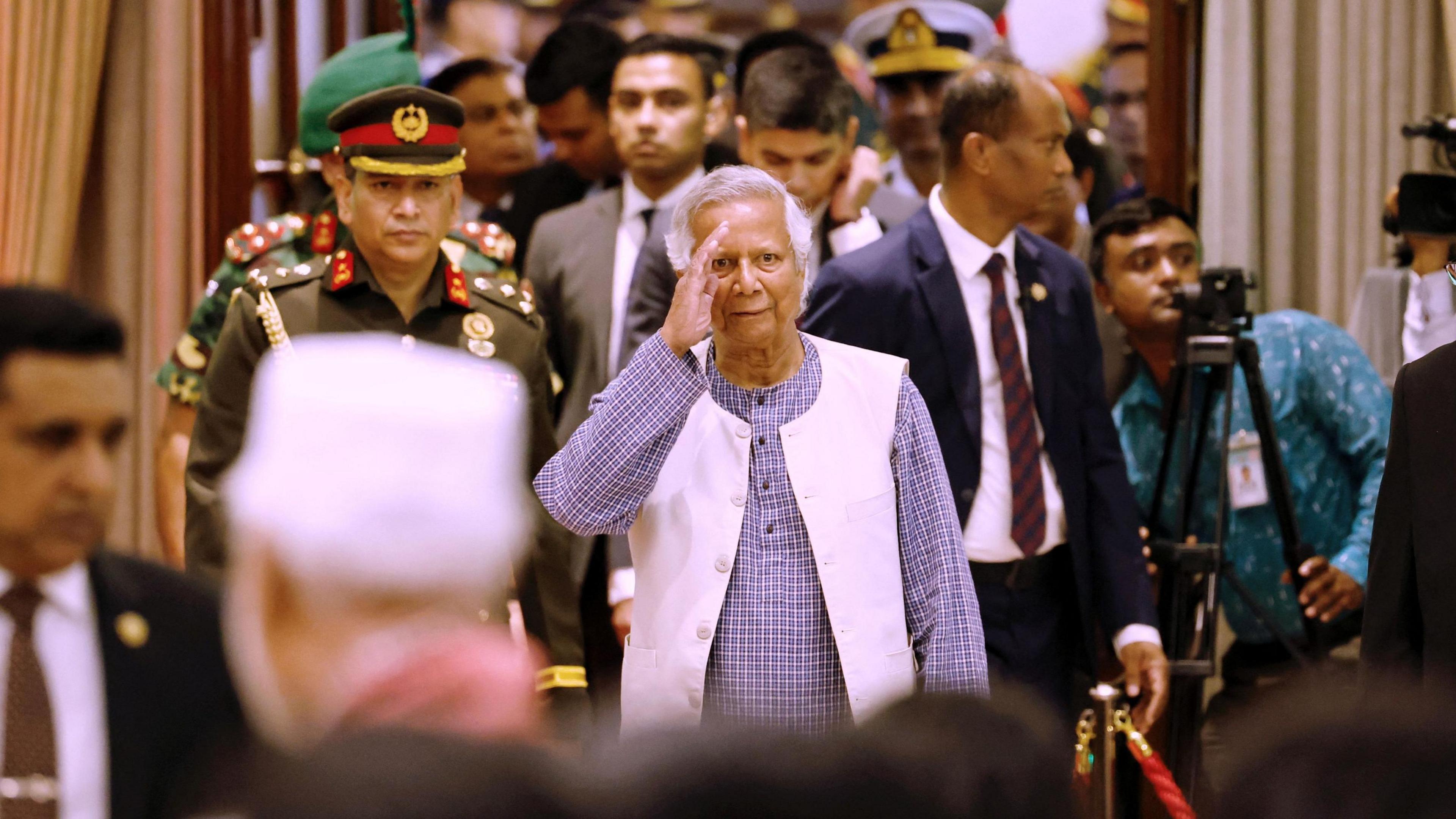 Nobel laureate Muhammad Yunus salutes at the ceremony to take oath as the head of the interim government