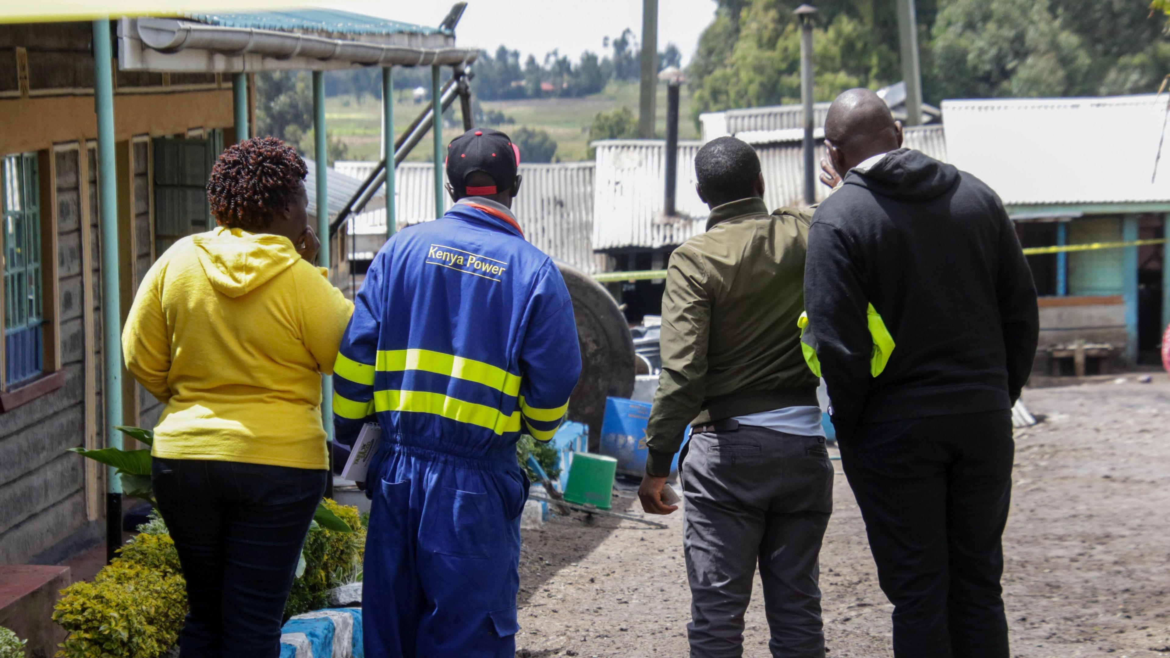 People inspect parts of the Hillside Endarasha Primary school following a fire